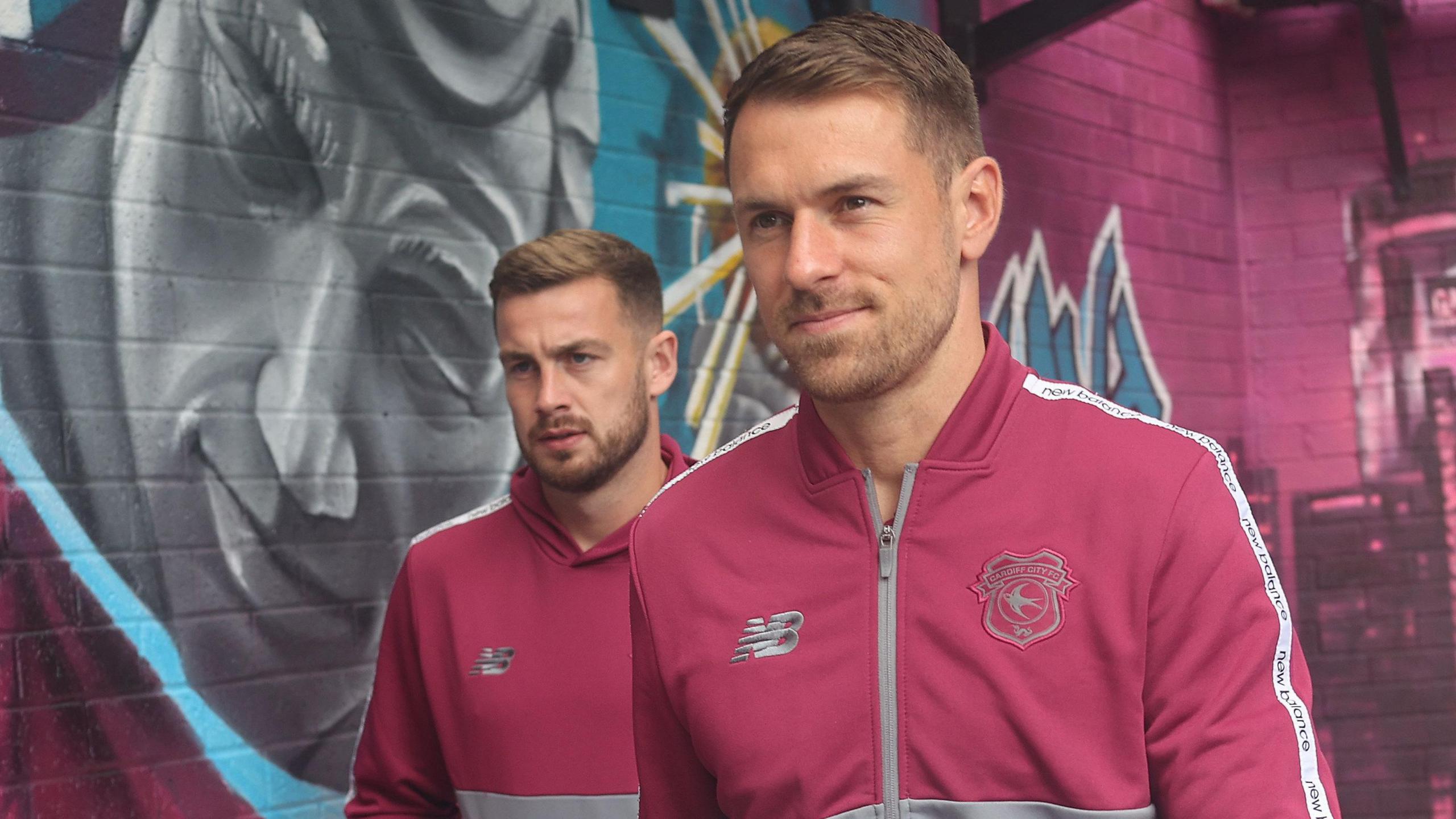 Joe Ralls (left) and Aaron Ramsey (right) look on