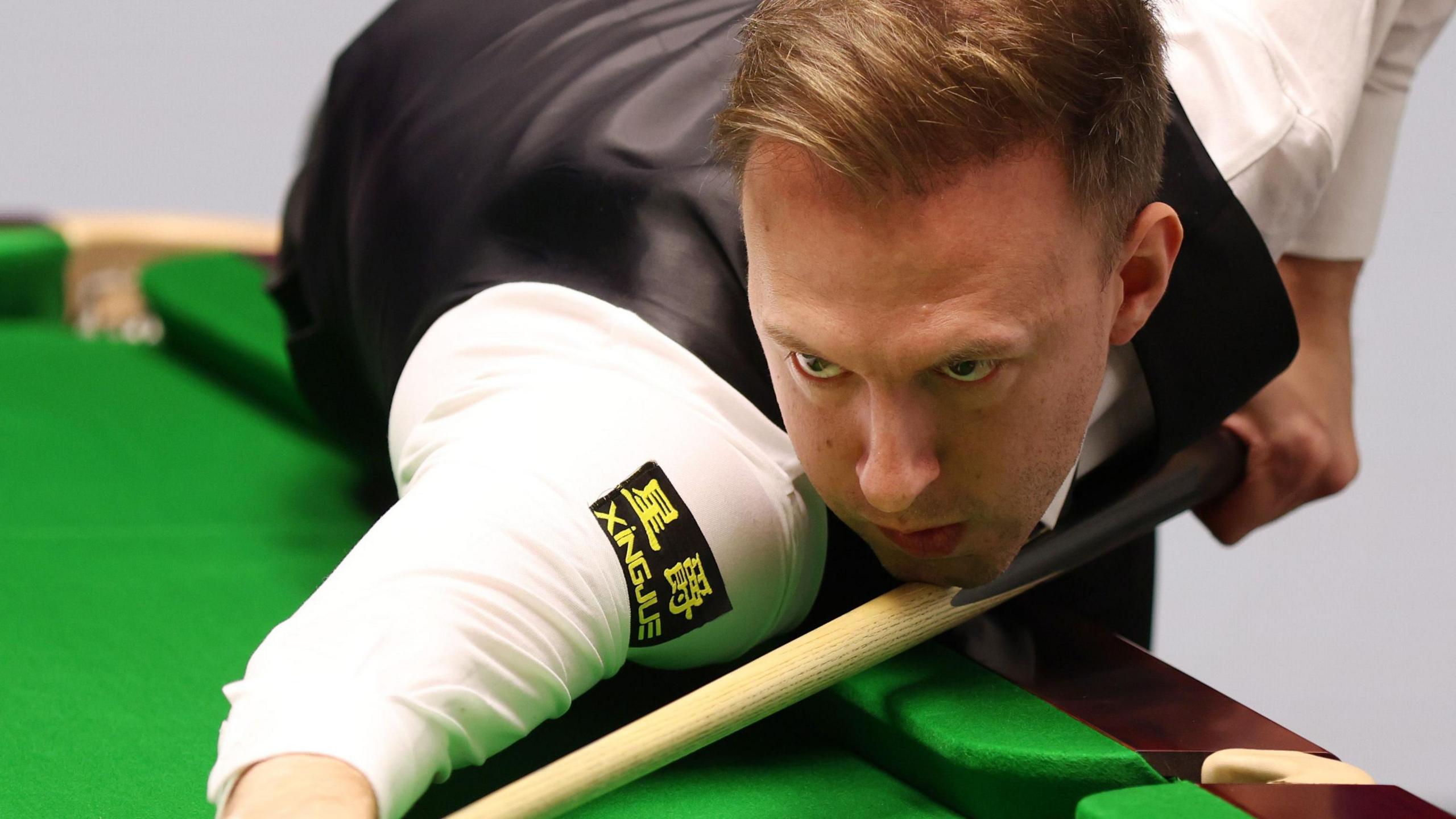 Judd Trump plays a shot