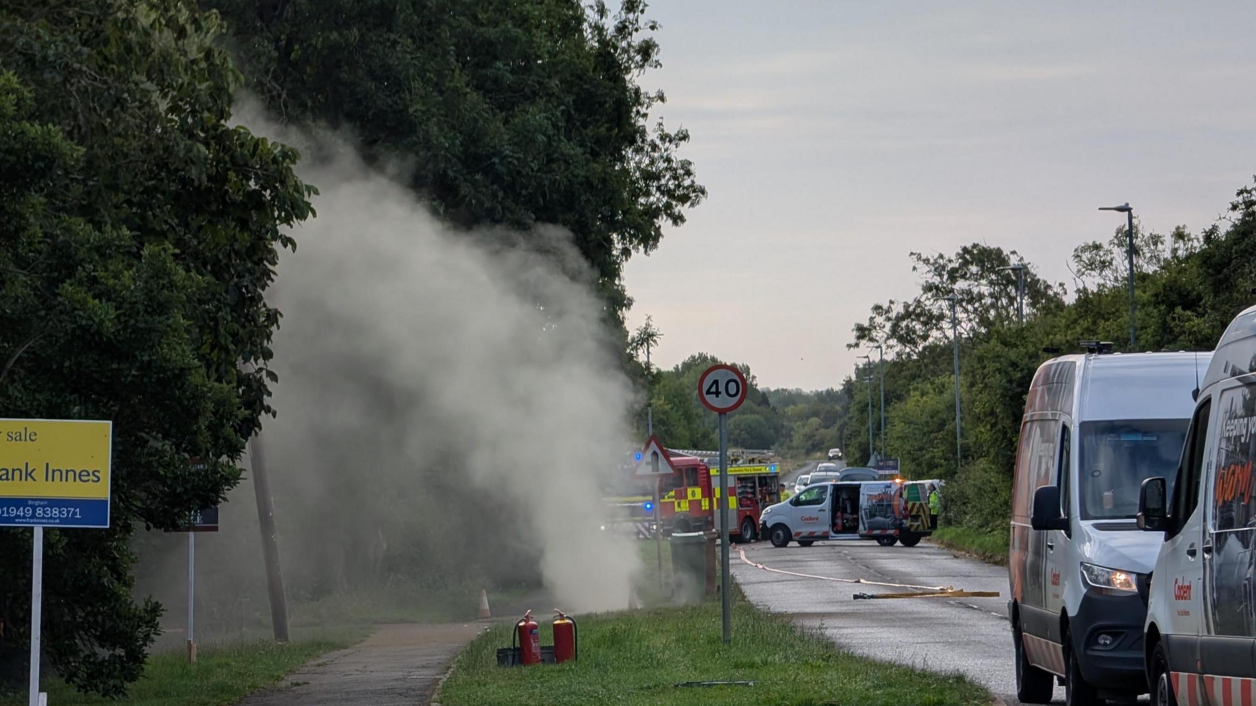 Gas rising into the air on Grantham Road, with a fire engine in the background