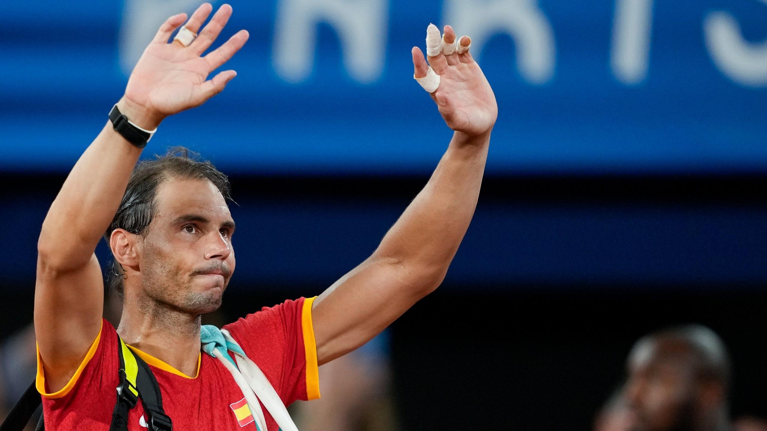 Rafael Nadal waves to the crowd at the Paris Olympics in 2024