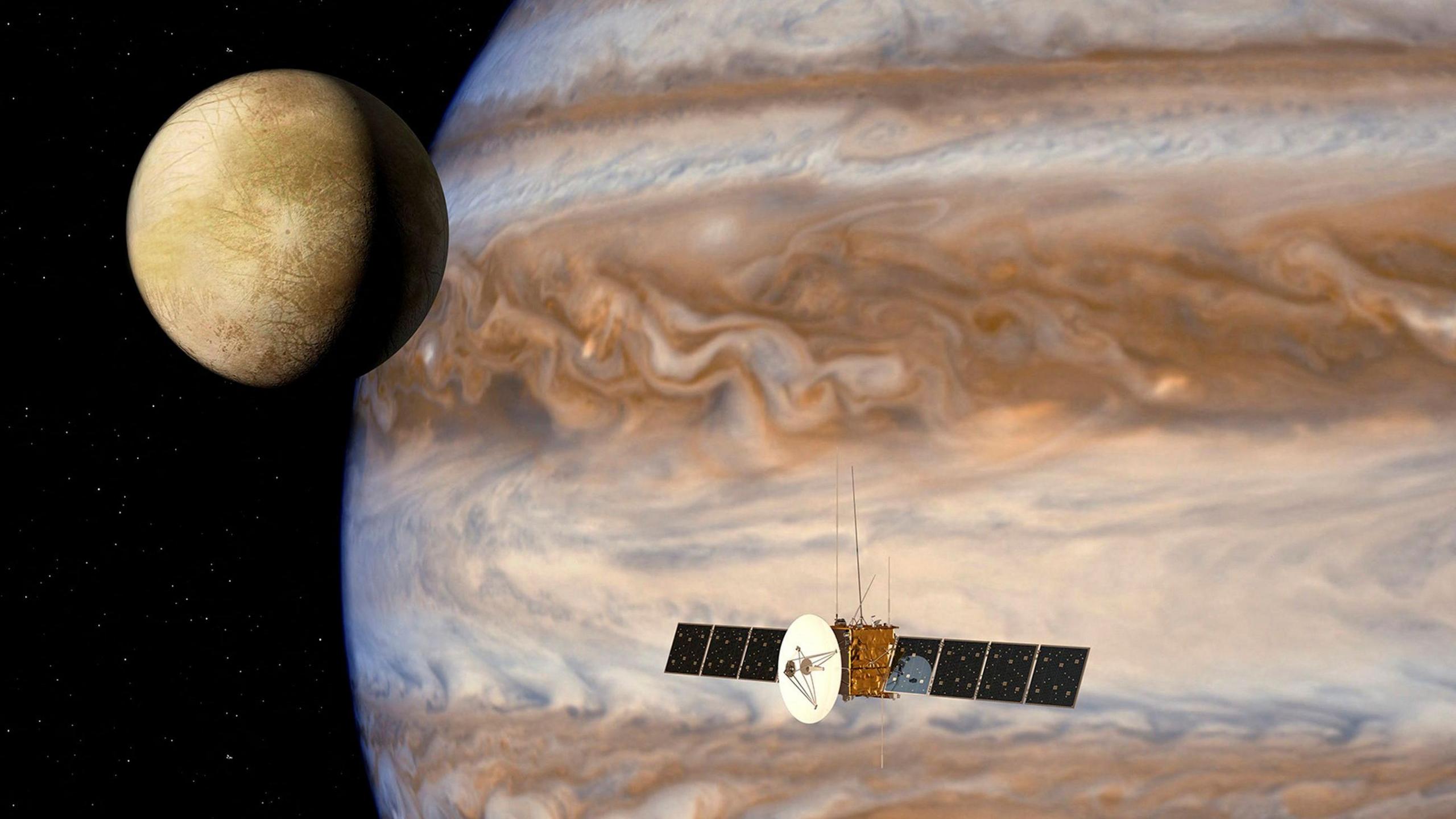 A computer generated impression of a spacecraft with large solar panels and a giant dish orbiting Jupiter alongside one of its moons