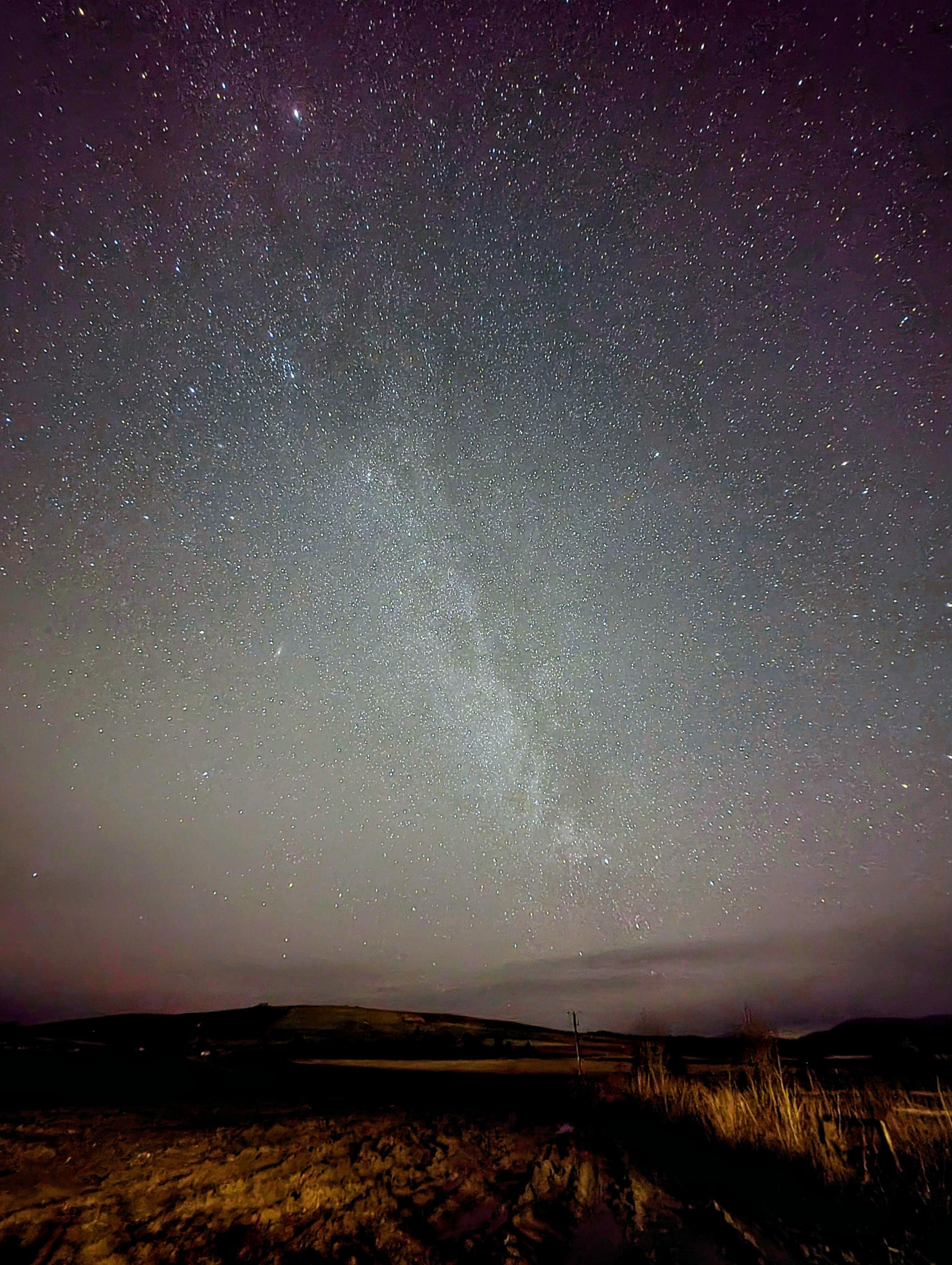 Long exposure image of stars and the Milky Way at night above Glen Esk