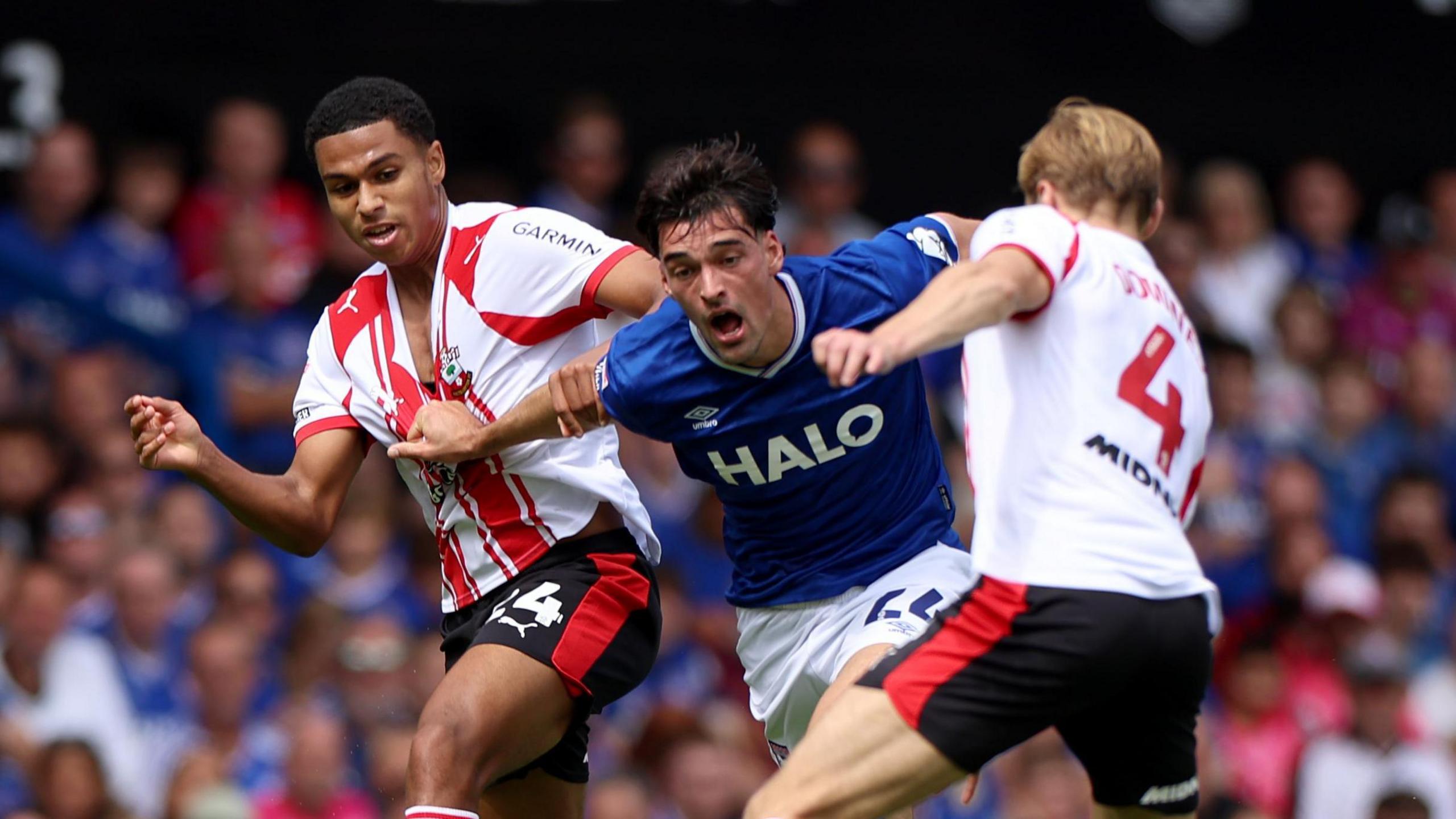Ipswich player Jacob Greaves (middle) is tussling between Shea Charles (no 24) and Flynn Downes (4) of Southampton