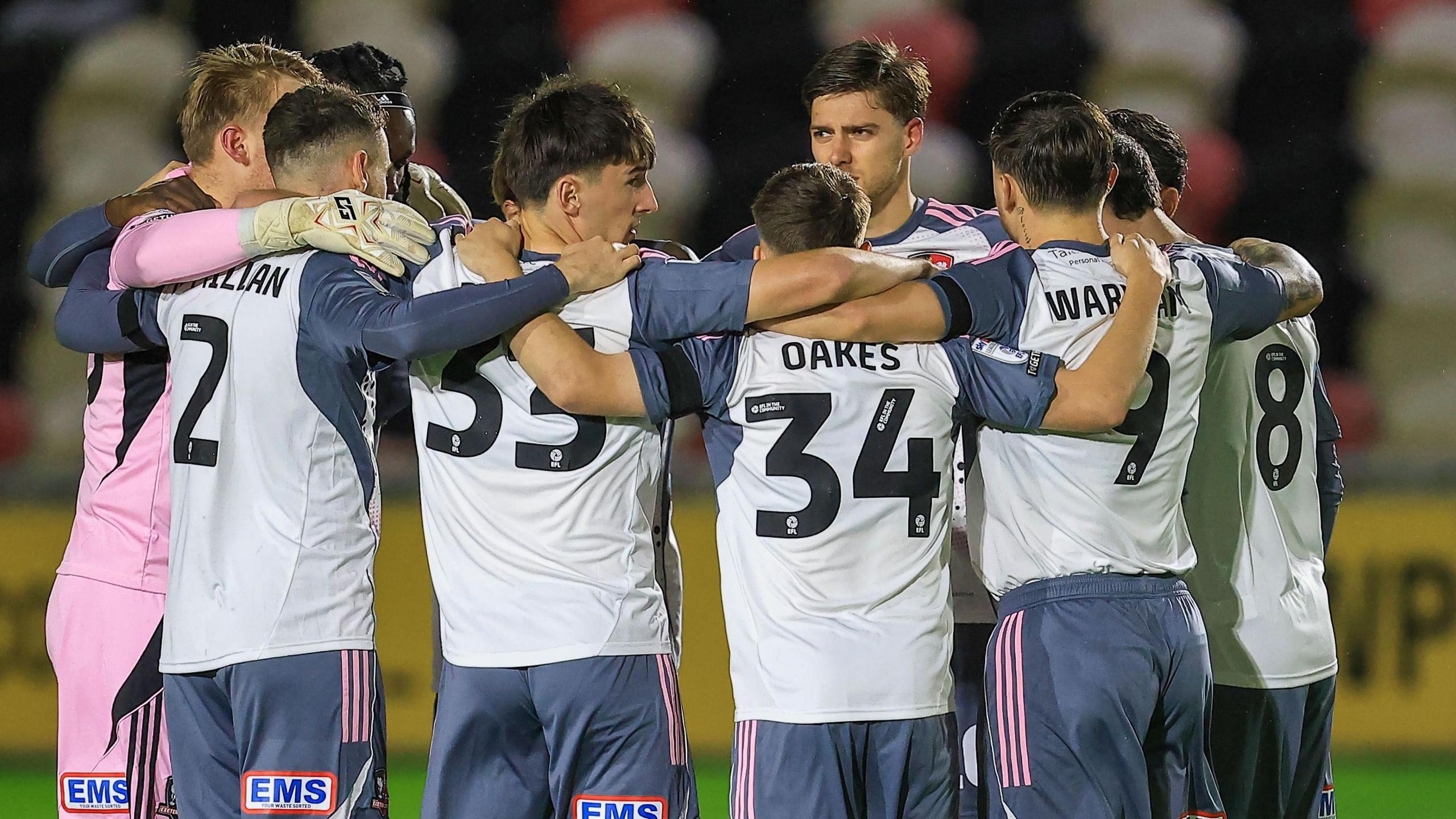 Exeter City players in a huddle