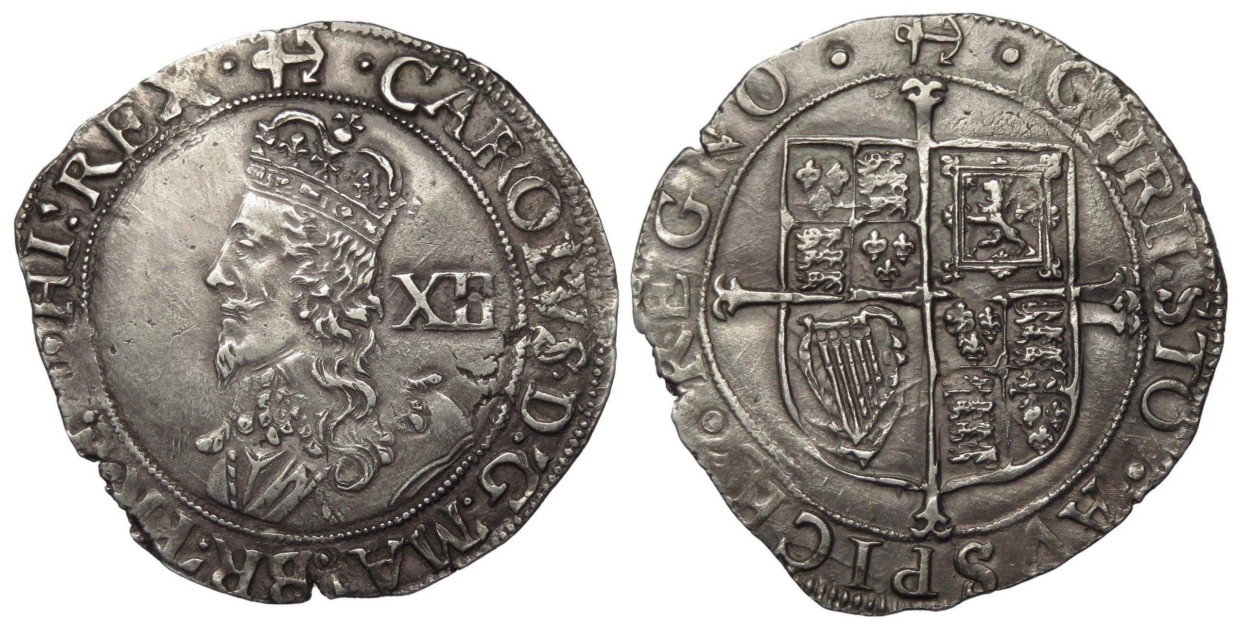 A front and back image of a Charles I silver shilling, worn at the edges but with clear markings. His profile is on the front with the letters XII and on the back is a coat of arms.