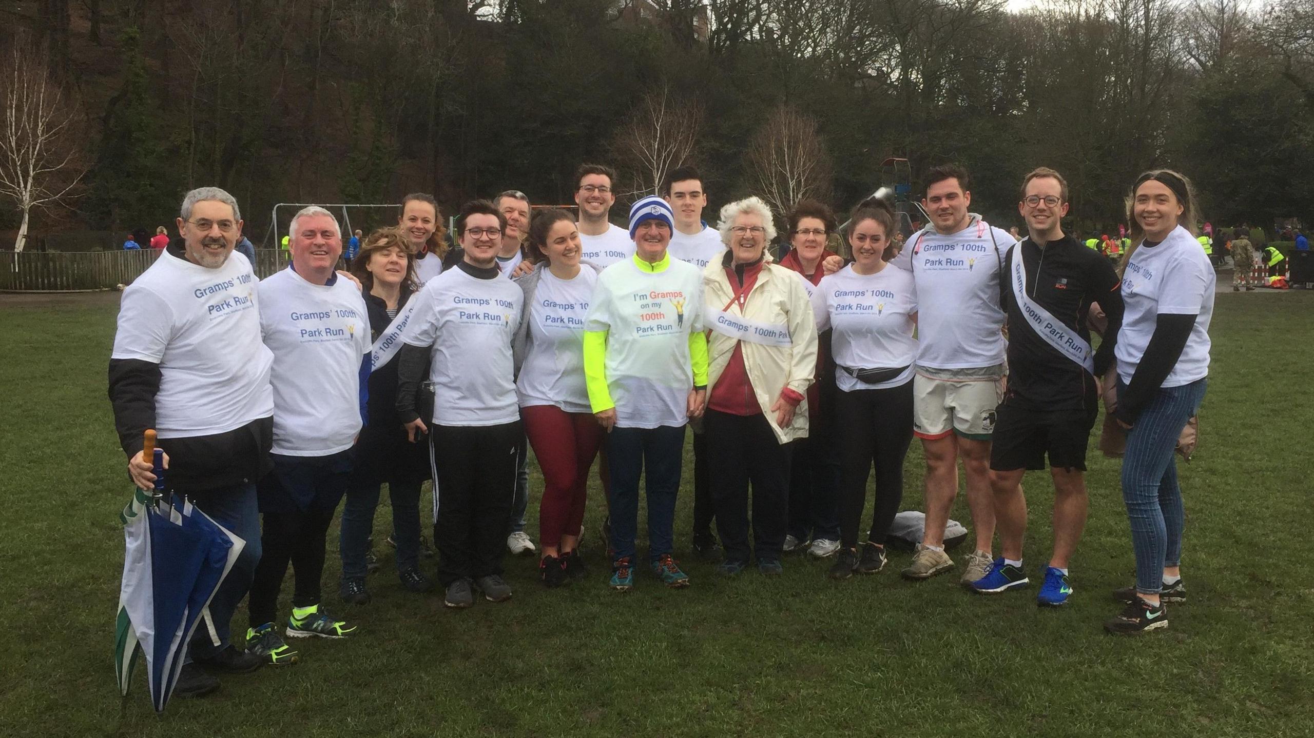 A group of runners in white T shirts 