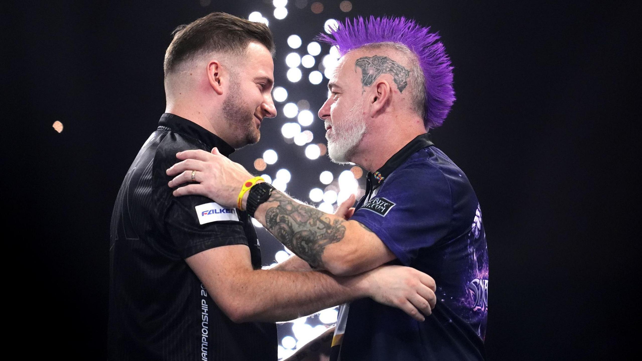 Arno Merk and Peter Wright embrace