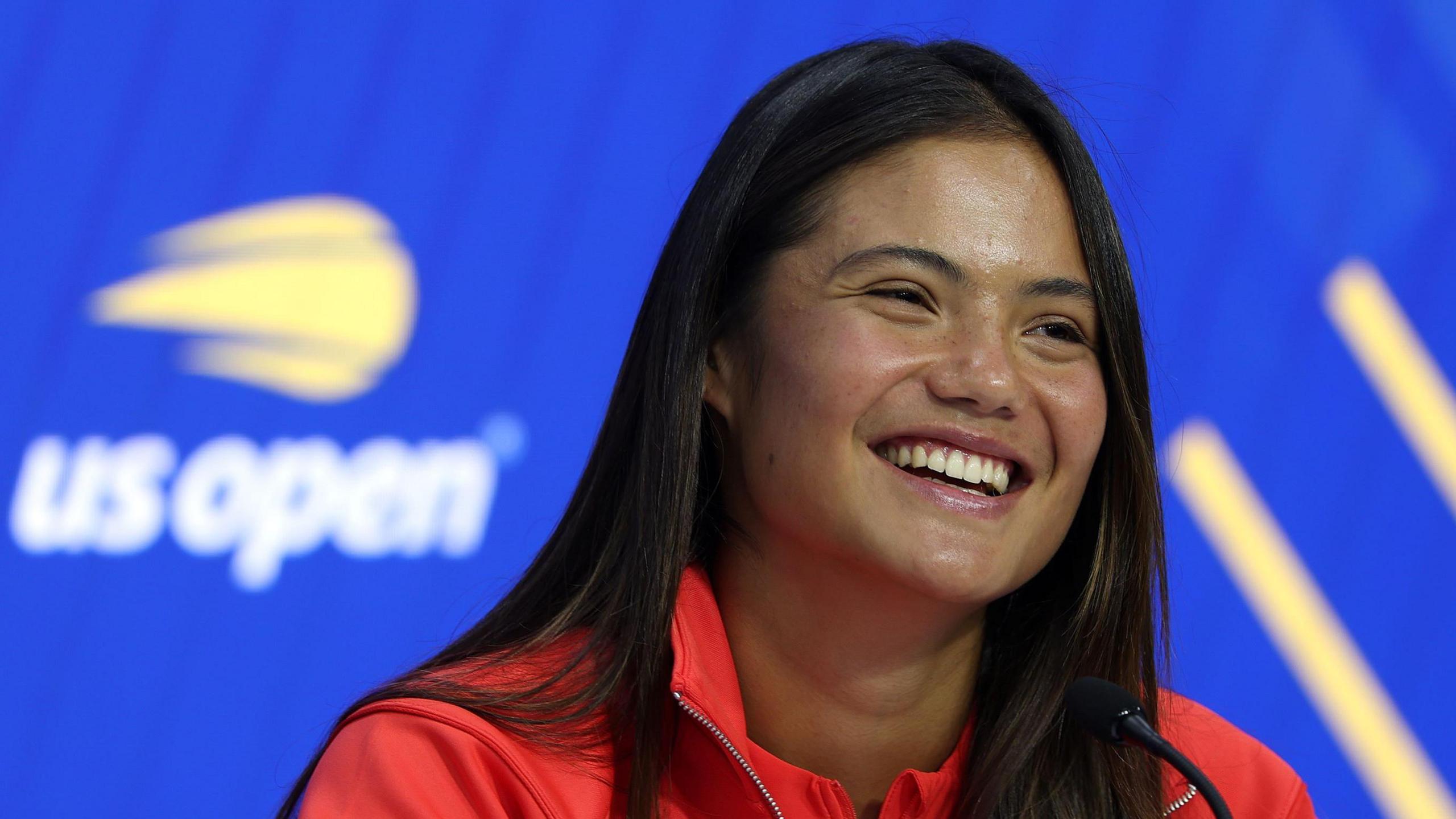 Emma Raducanu smiles during her US Open news conference