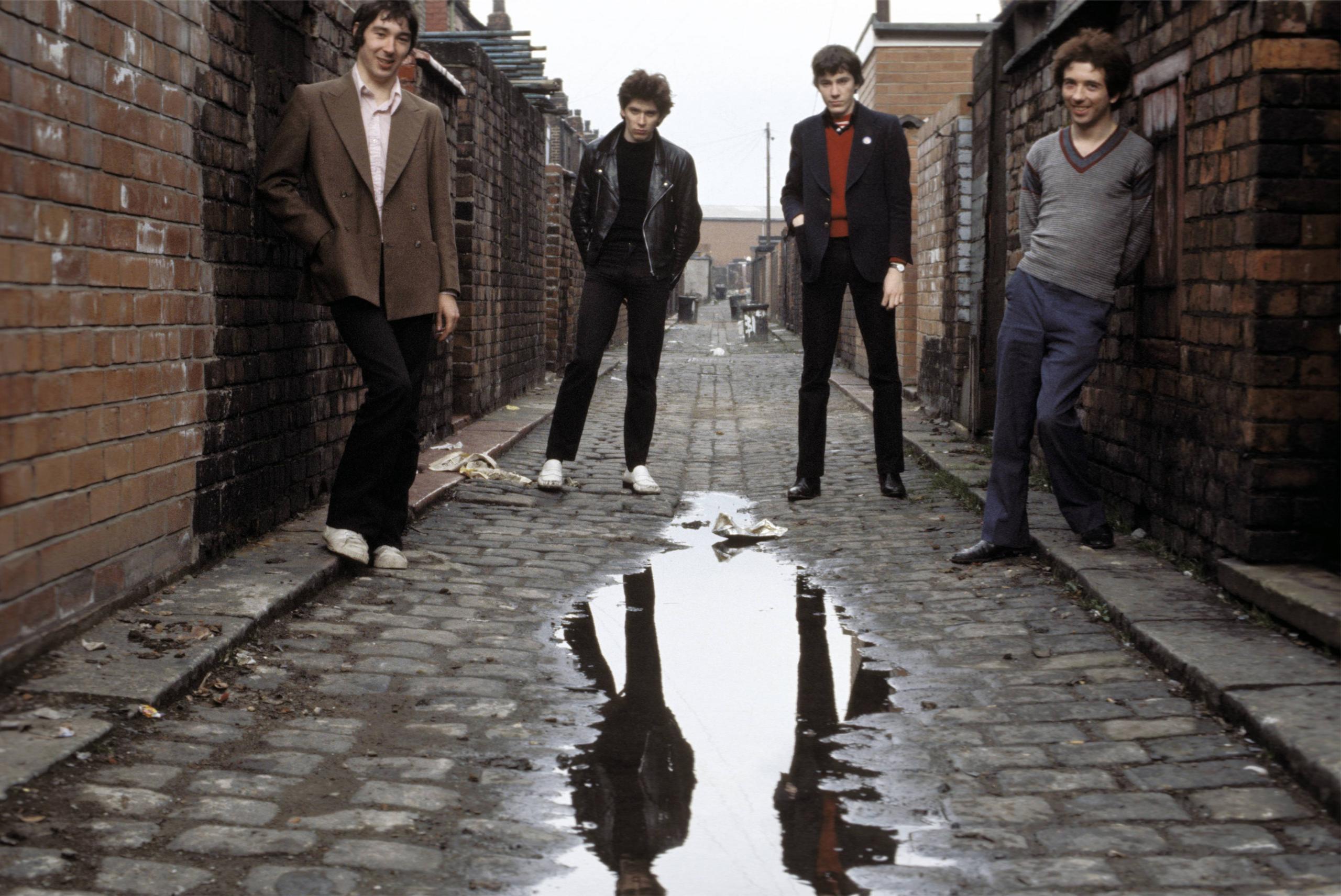 From left: Steve Diggle, Steve Garvey, John Maher and Pete Shelley of Buzzcocks, posing in a ginnel