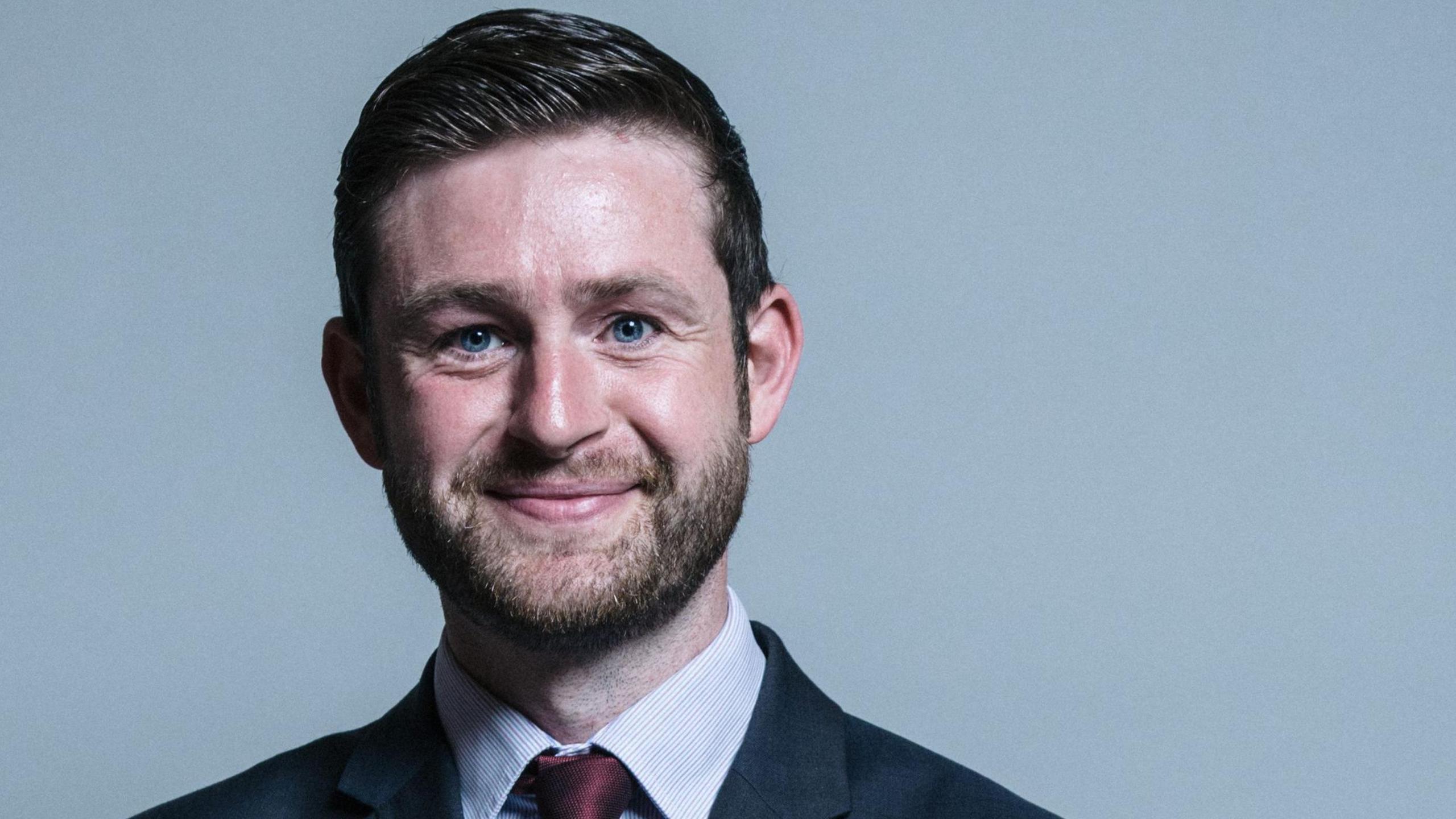 Parliamentary portrait of Jim McMahon, wearing a suit and tie.