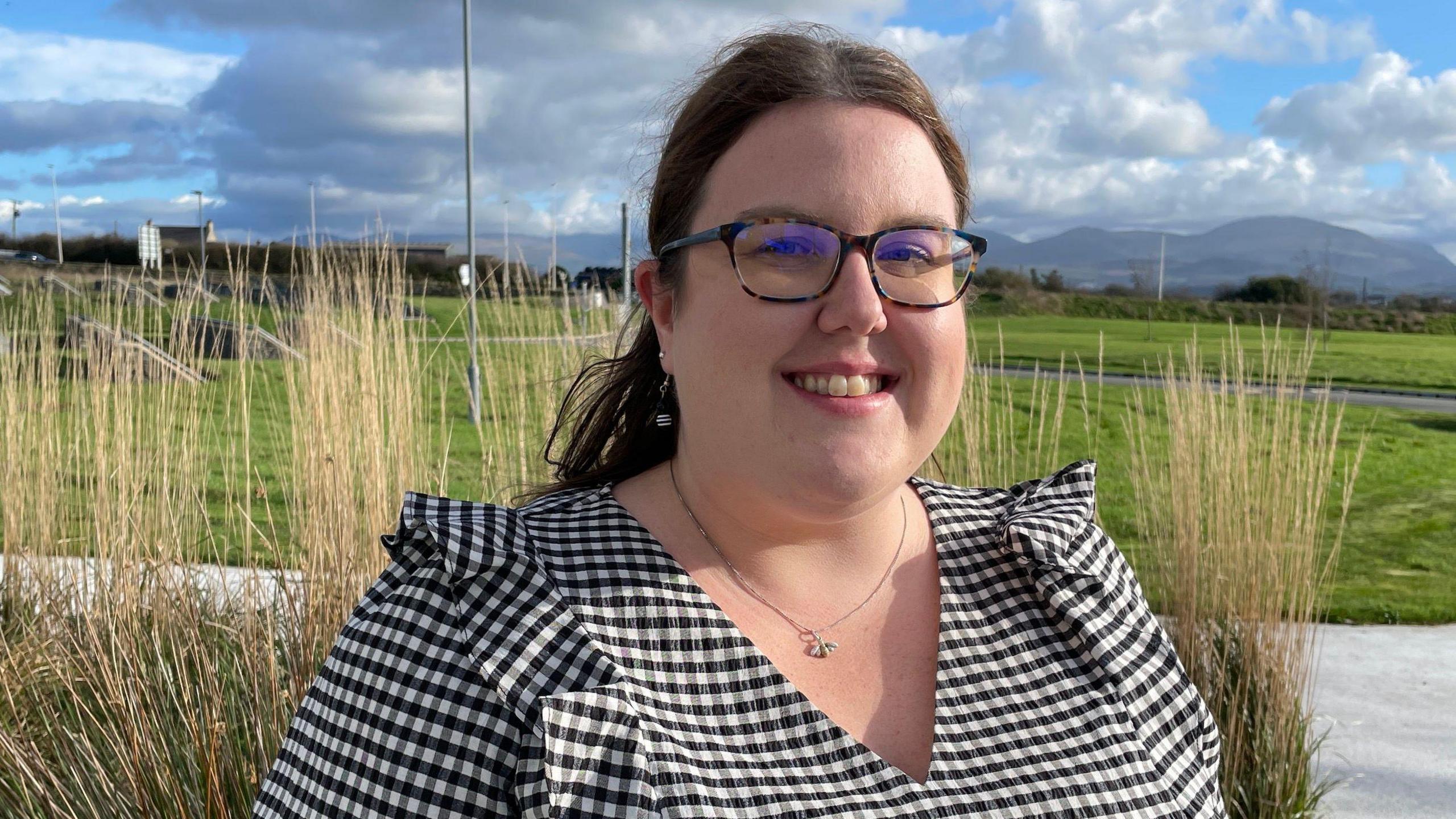 Dr Debbie Jones at the M-SParc science park wearing a black and white checked dress and glasses