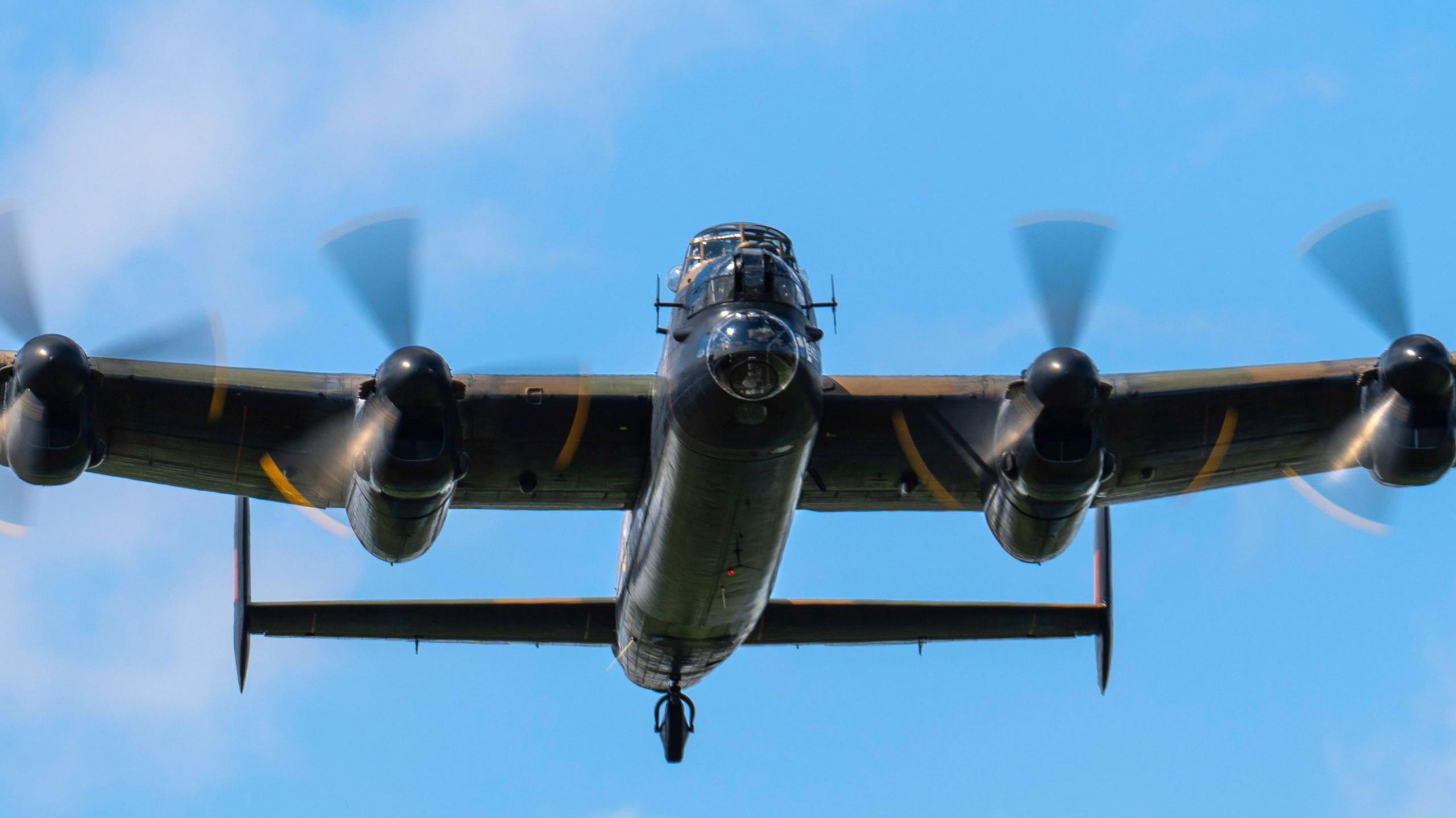 A close look at the plane from underneath, with its propellers and undercarriage in clear view