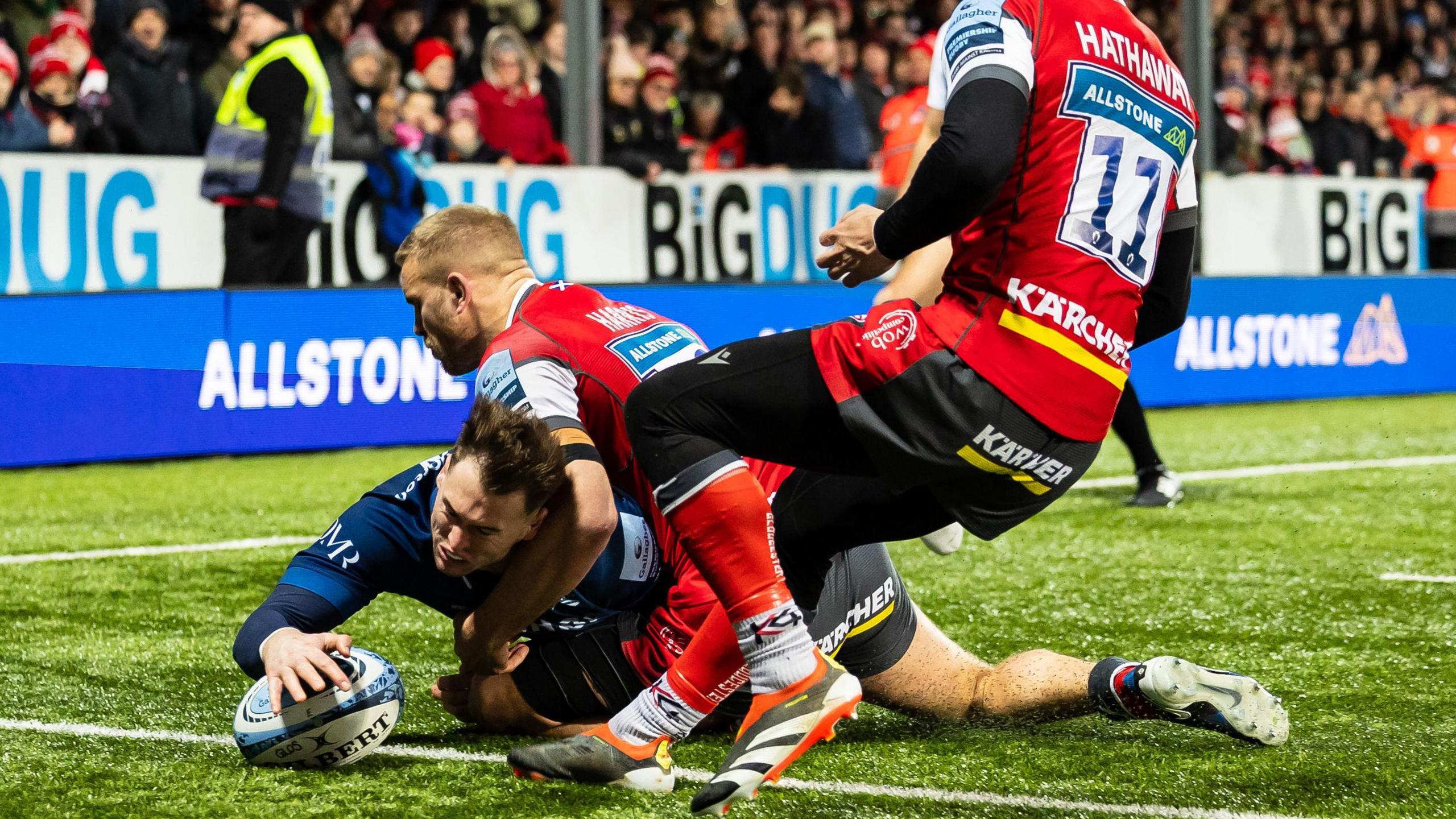 Sale winger Tom Roebuck dives over in the corner to score.