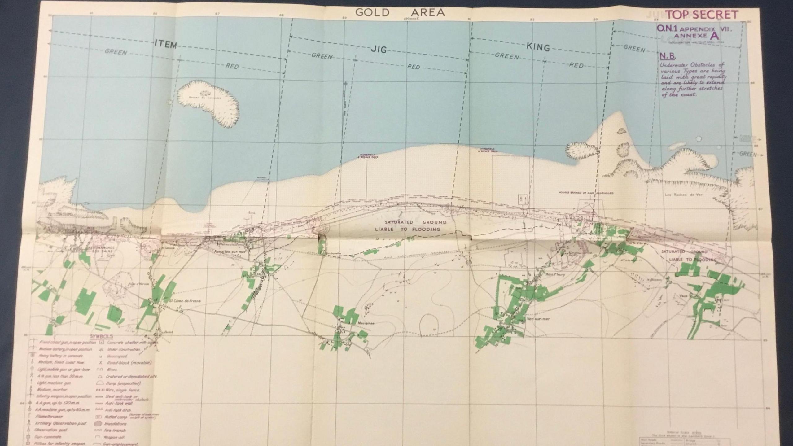 A map of the area around Gold beach in Normandy, France. It is marked as "top secret" and features markings in purple, green and black.