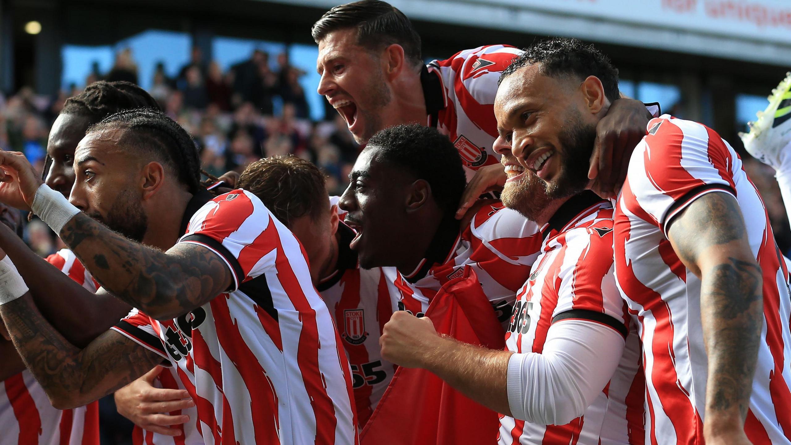 Stoke City players observe scoring a goal
