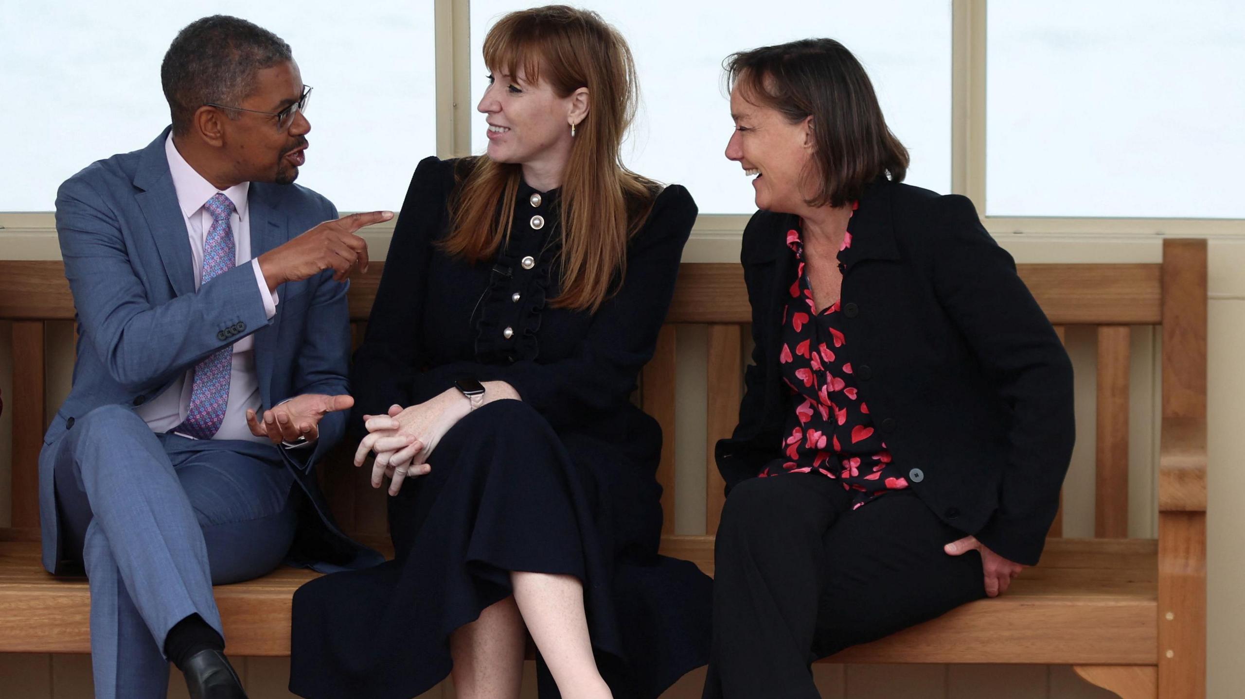 Vaughan Gething, Angela Rayner and Jo Stevens talk in a beach shelter