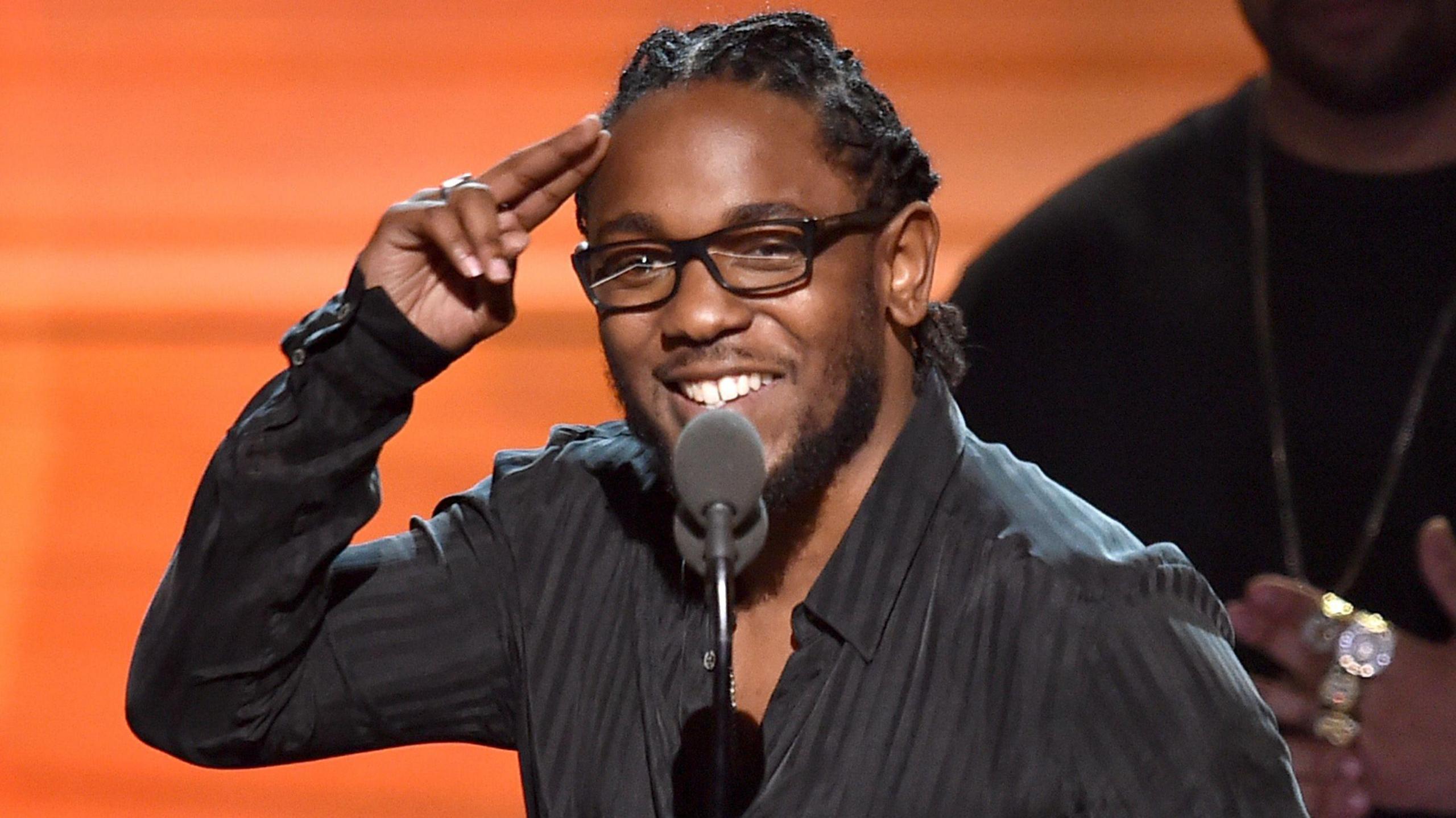 Kendrick Lamar salutes fans during an acceptance speech at the 2016 Grammy Awards