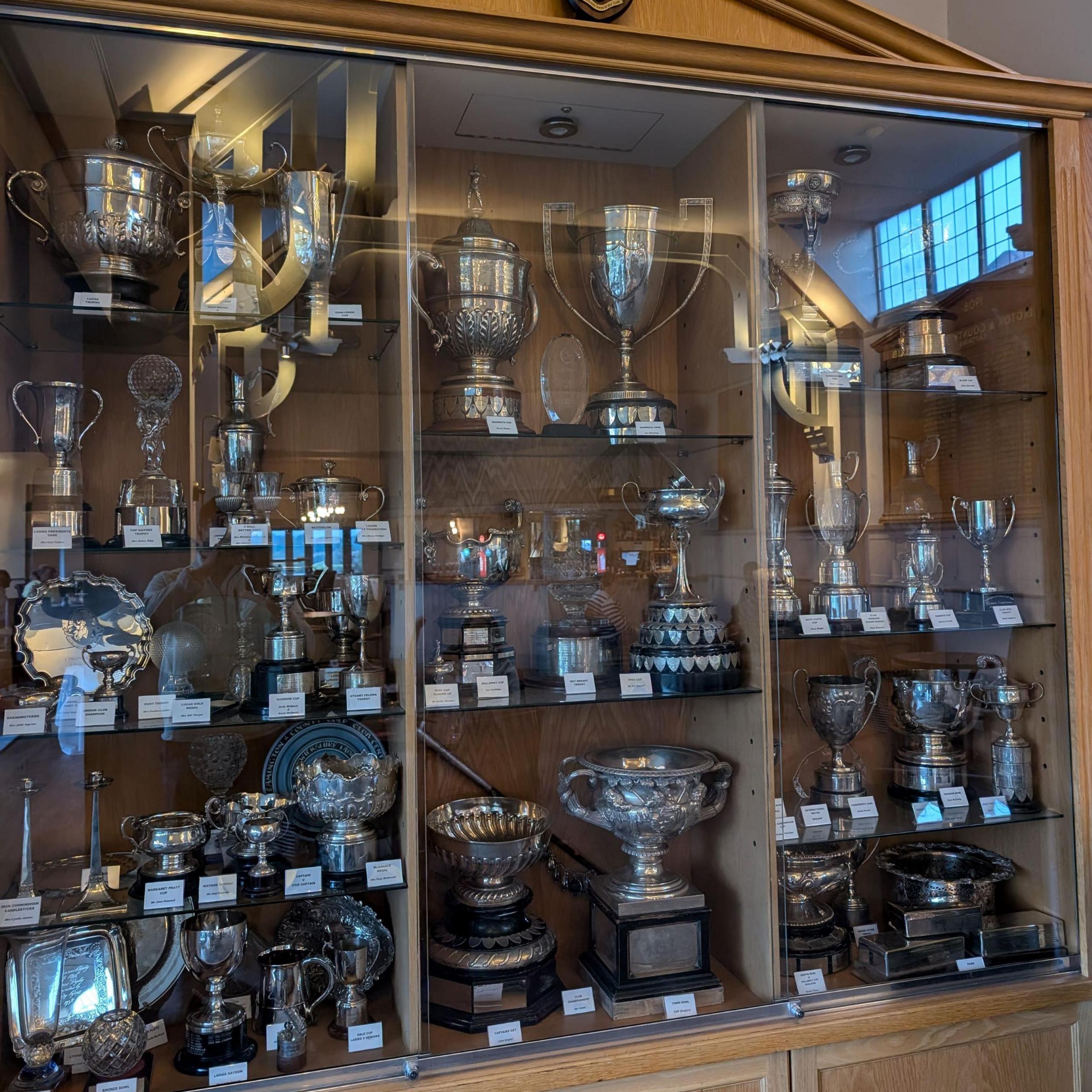 The trophy cabinet before the break, full of large silver cups.