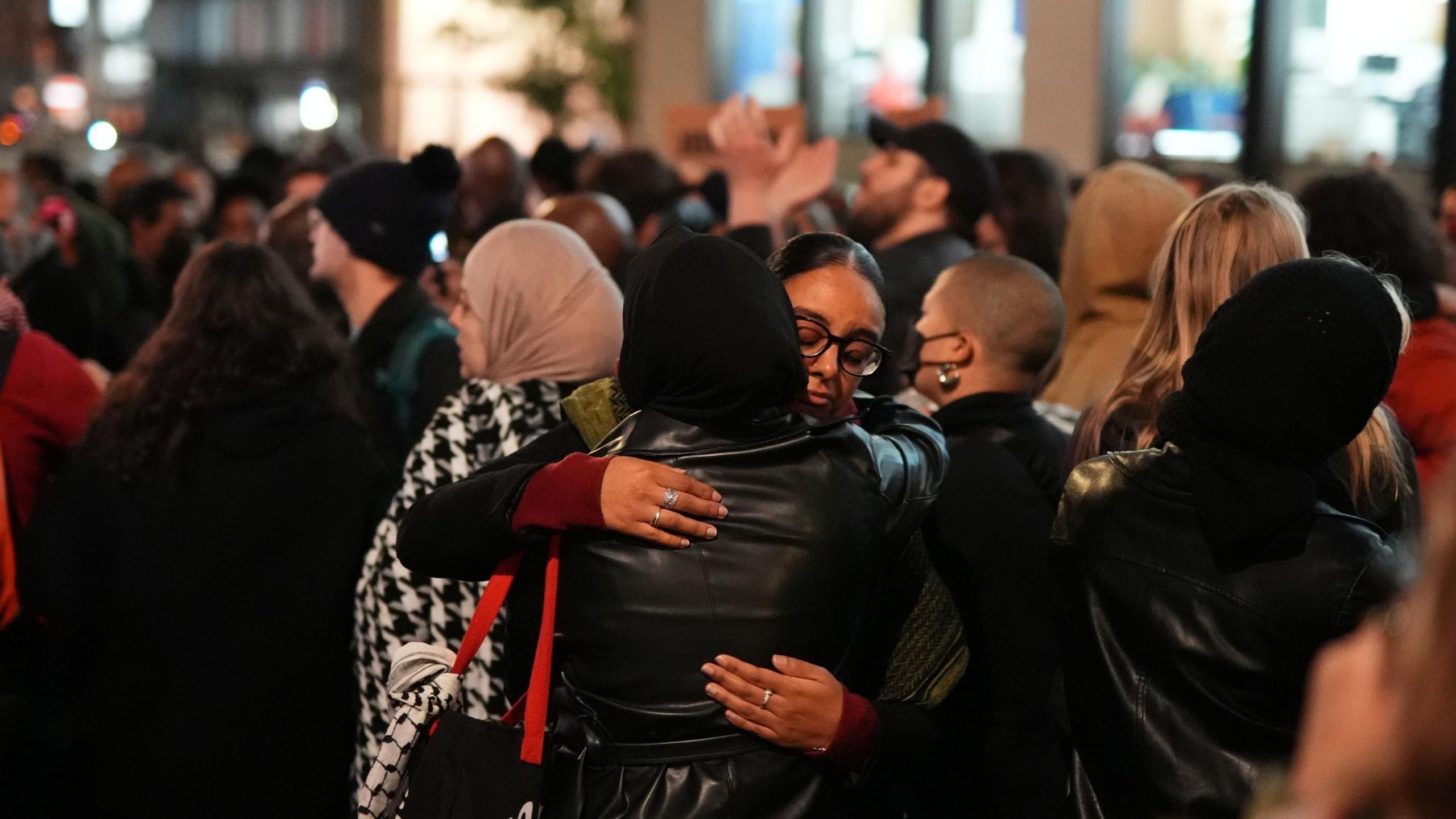 Two women embrace during a vigil outside the Old Bailey following the Chris Kaba verdict on Monday