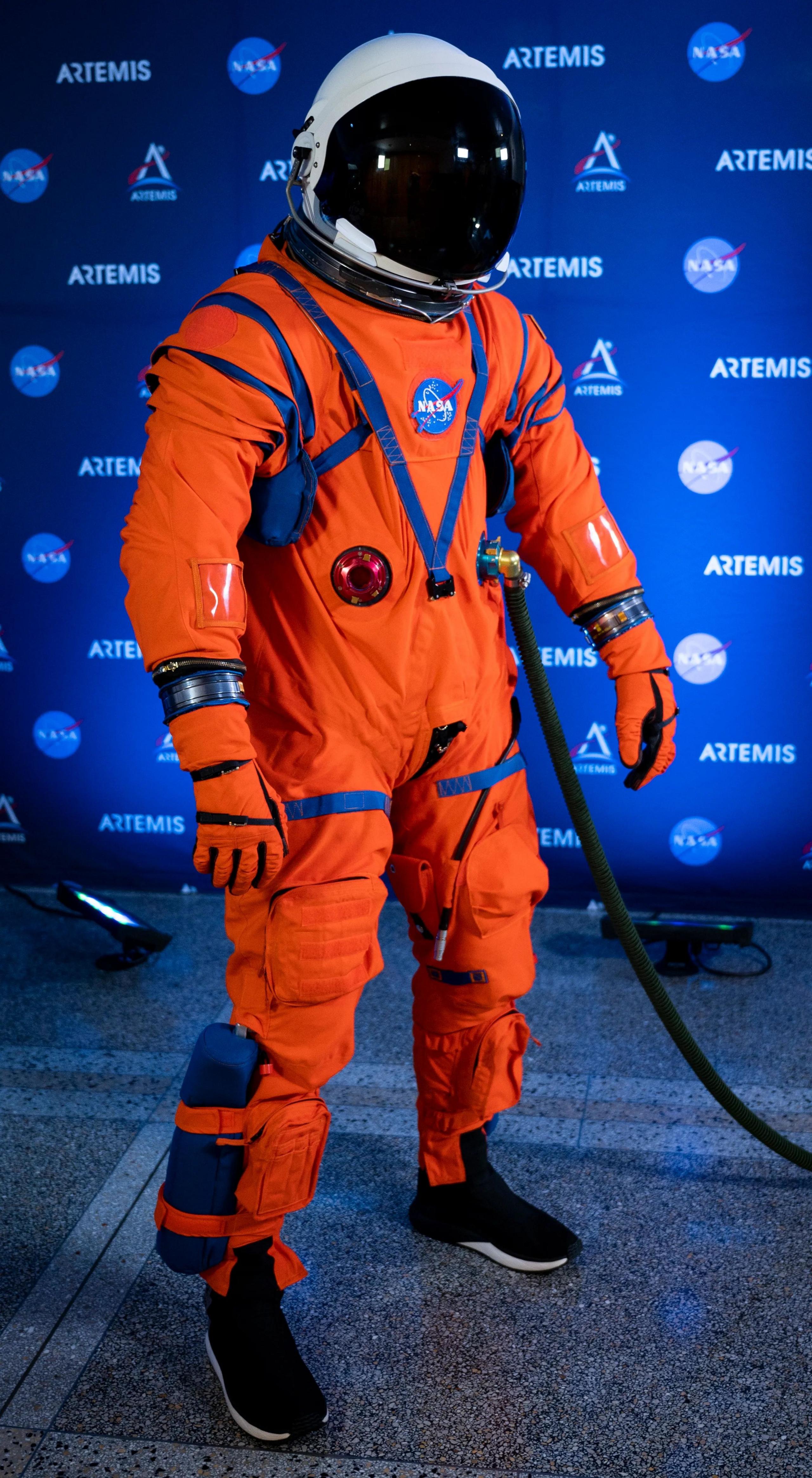 Orion Crew Survival System is a bright orange space suit with a white helmet with black visor