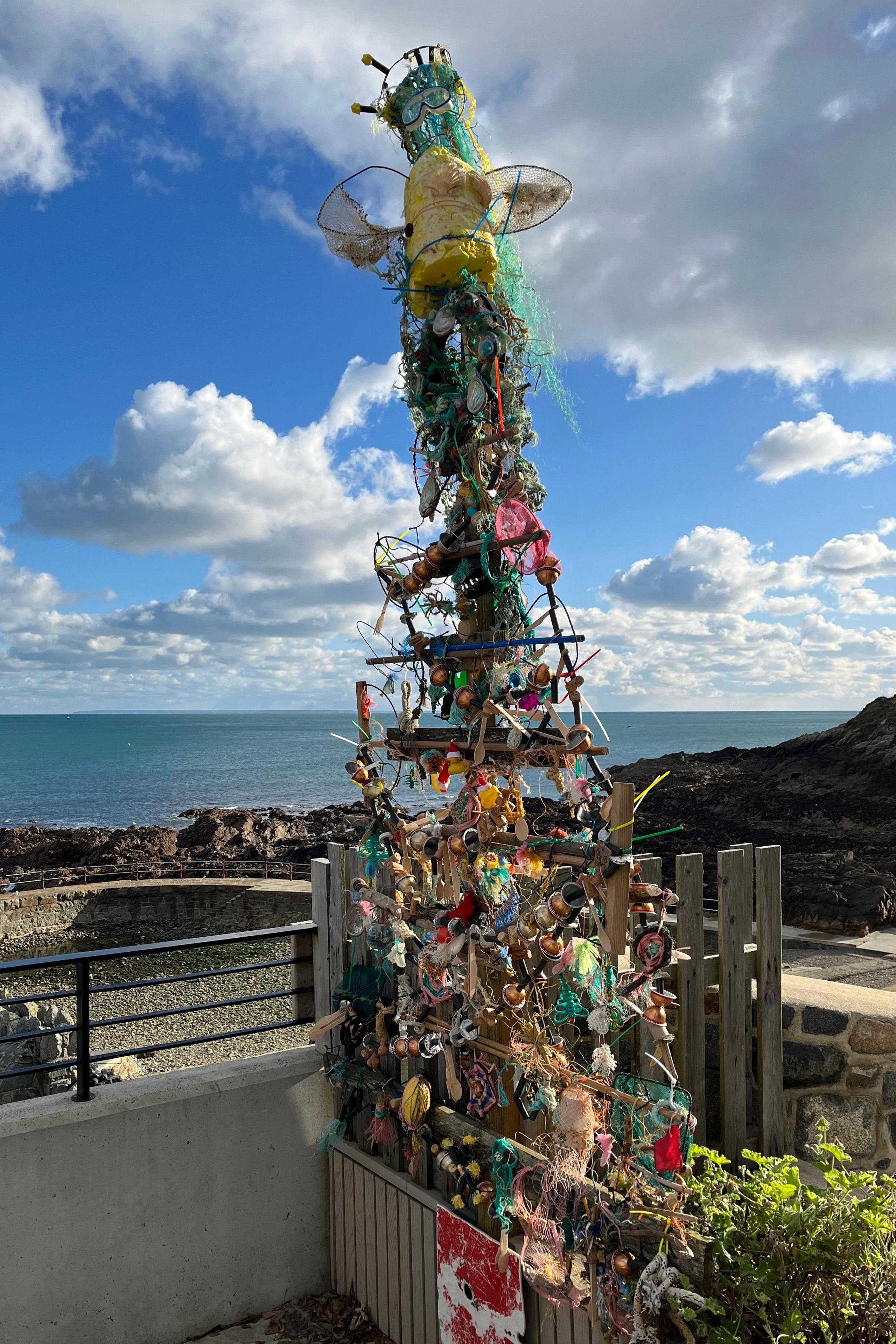 The Vive La Vallette Christmas Tree in full. The 'angel' on the top is made from an old snorkel mask. The sea is in the background.