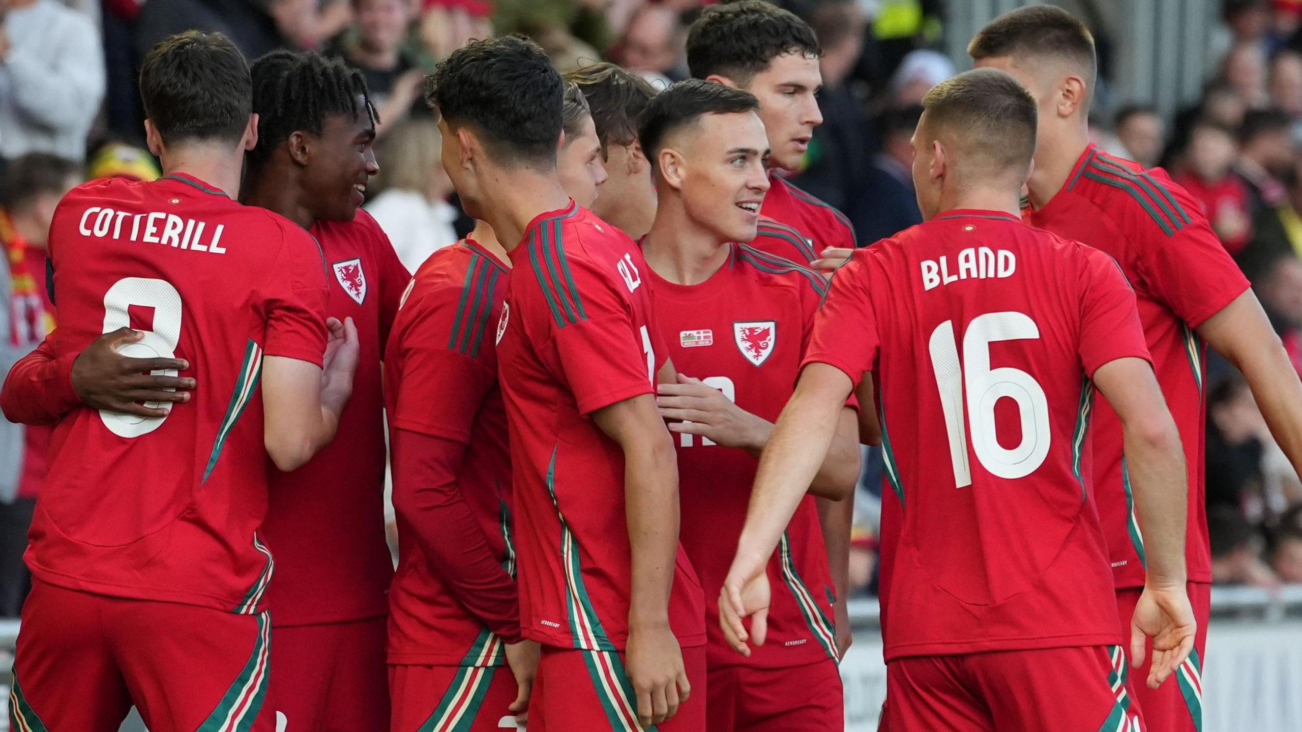 Wales Under-21s celebrate scoring a goal against Denmark