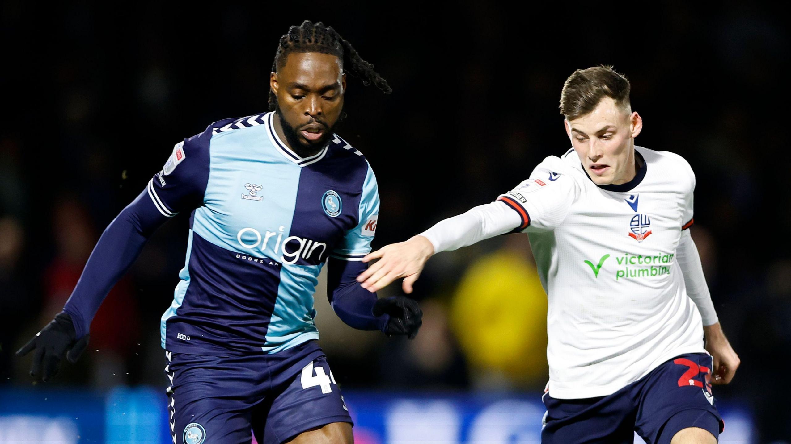 Wycombe's Fred Onyedinma and Bolton's Szabolcs Schon battle for the ball