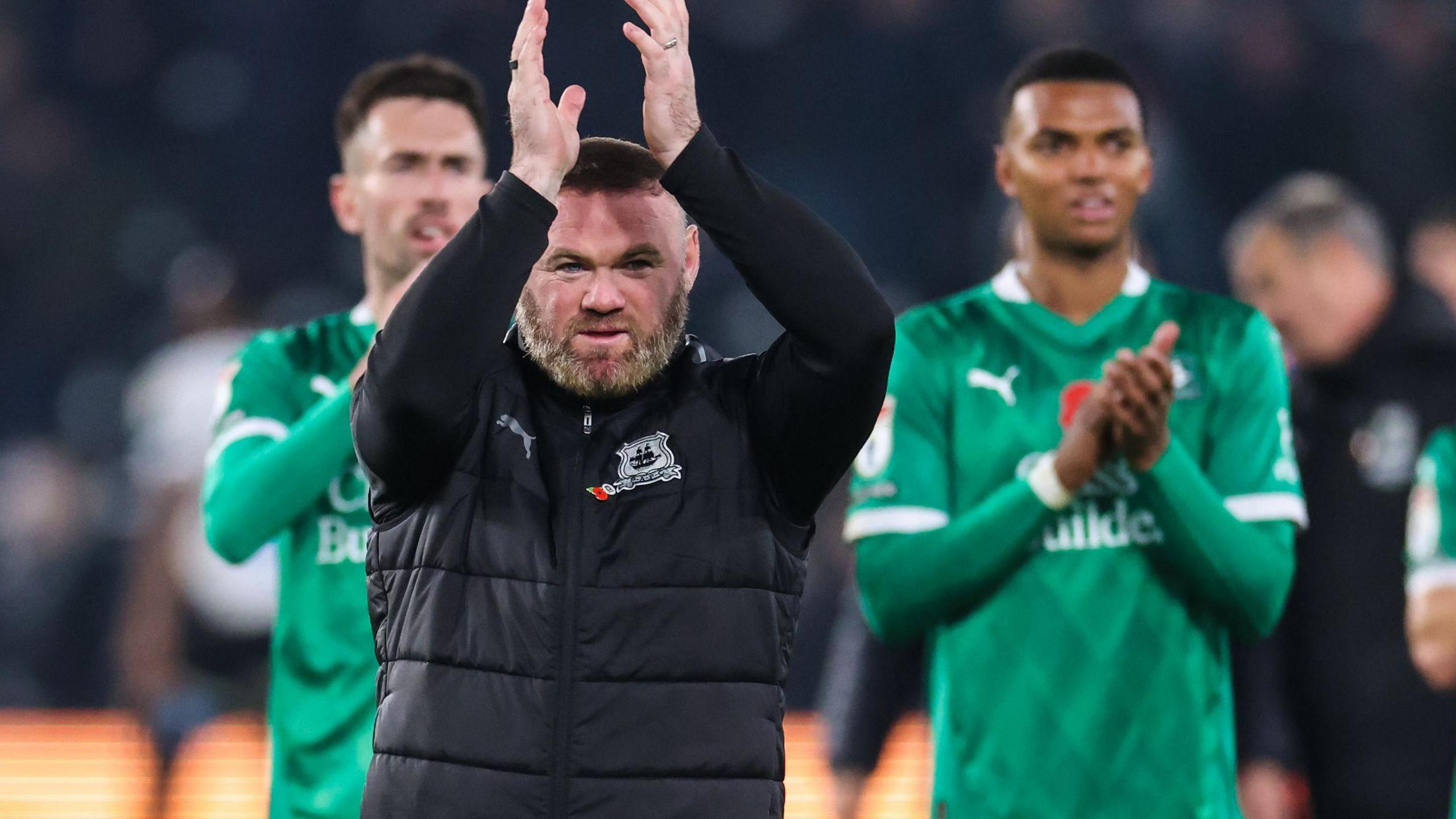 Wayne Rooney applauds the Argyle fans