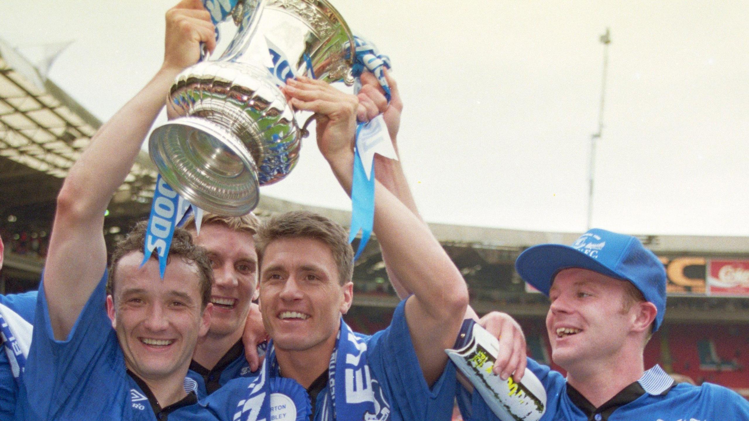 Barry Horne holds the FA Cup aloft with goalscorer Paul Rideout and Graham Stuart following Everton's 1-0 win over Manchester United at Wembley in May 1995