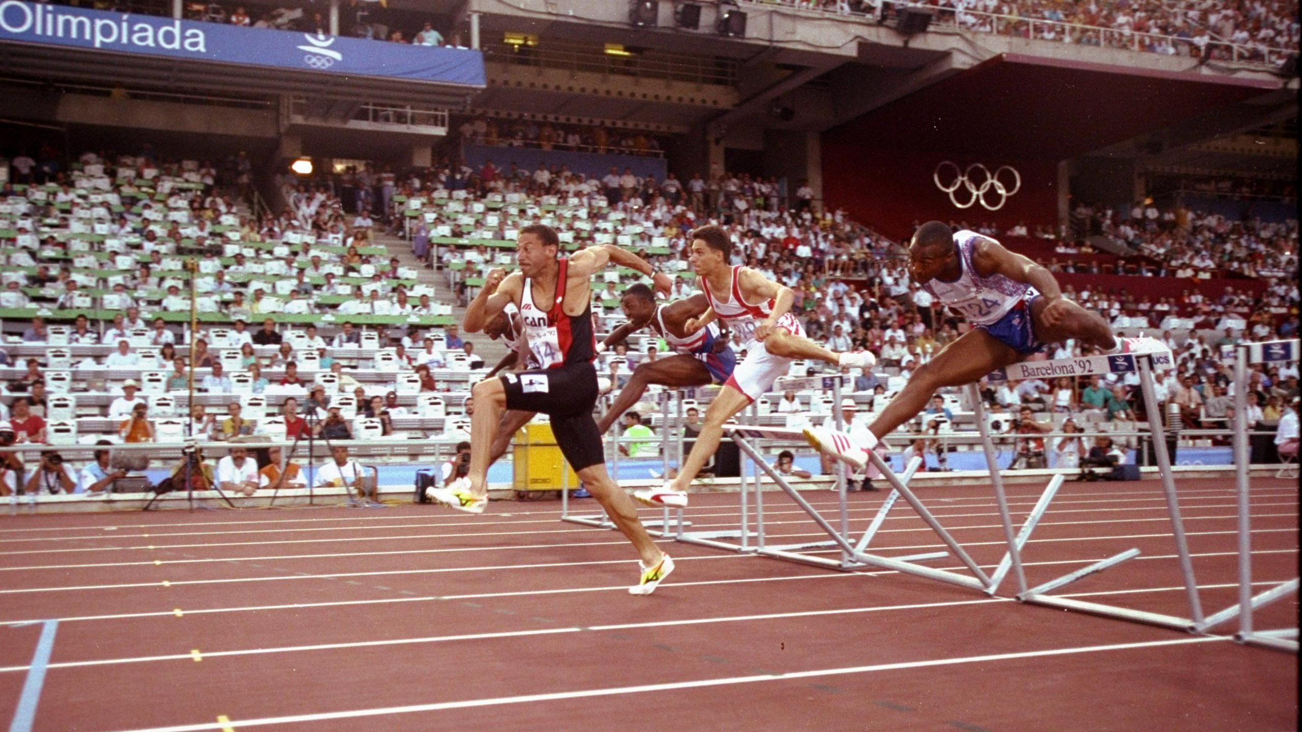 Mark McKoy of Canada leads from Colin Jackson of Great Britain during the 110 metres Hurdles event of the 1992 Olympic Games at the Monjuic Stadium in Barcelona, Spain. 
