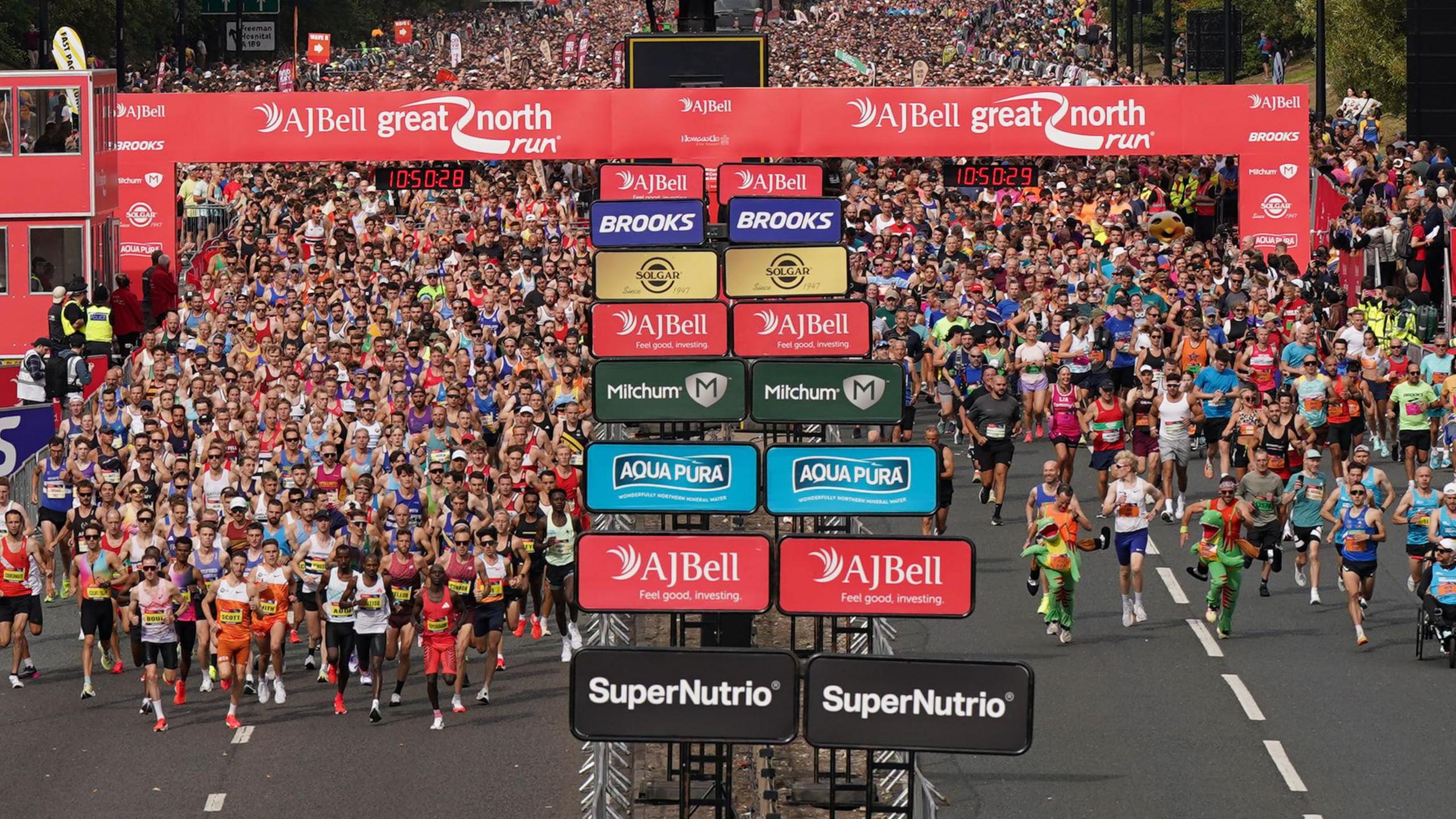 thousands of runners setting off from the starting line.