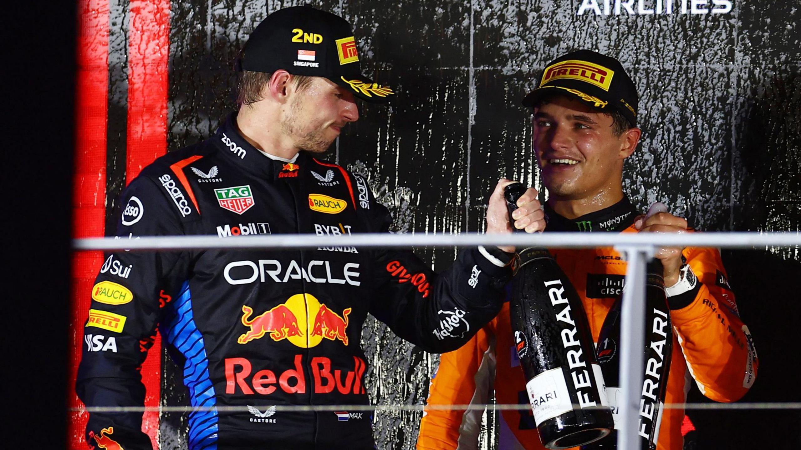 Max Verstappen congratulates Singapore Grand Prix winner Lando Norris on the podium