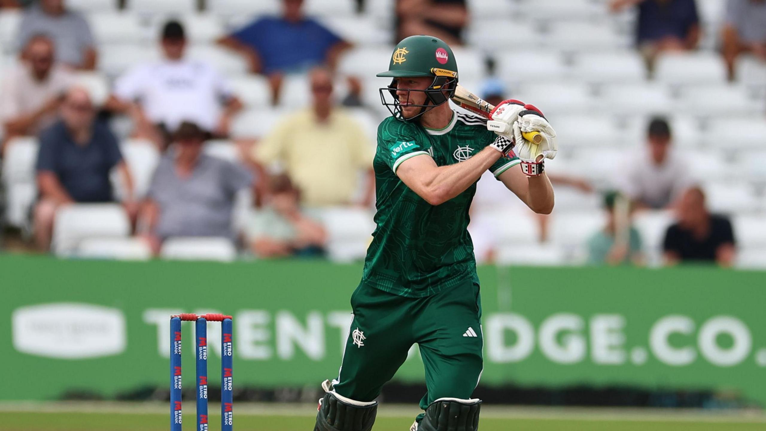 Lyndon James in the dark green kit of Notts Outlaws, plays a shot