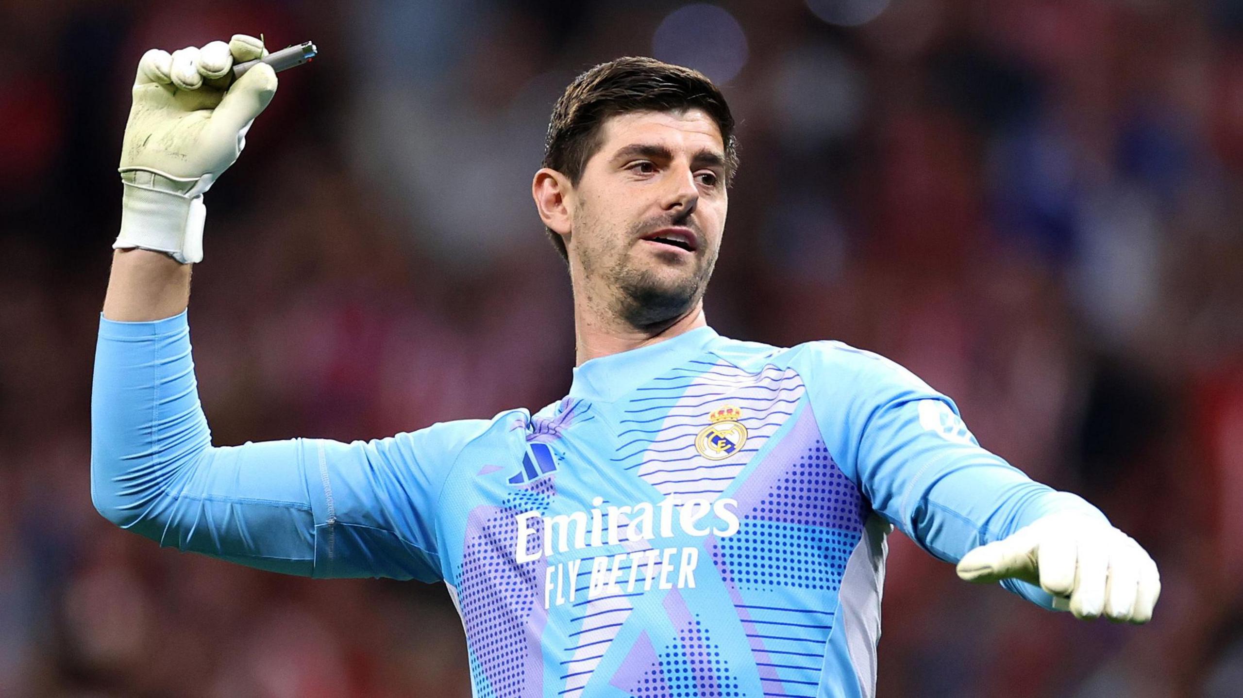 Real Madrid goalkeeper Thibaut Courtois with a lighter in his right glove