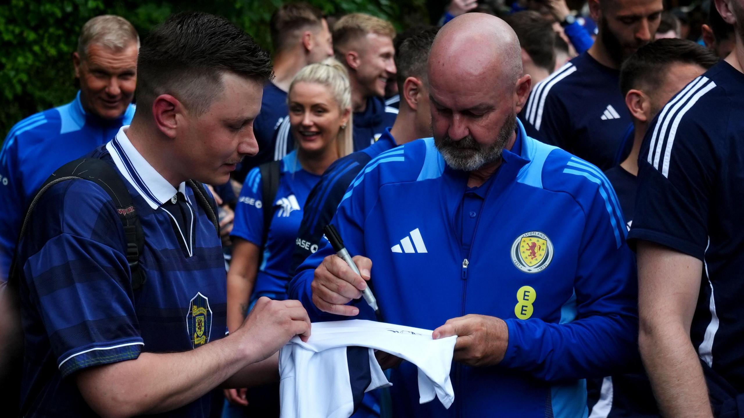 Scotland head coach Steve Clarke signing an autograph