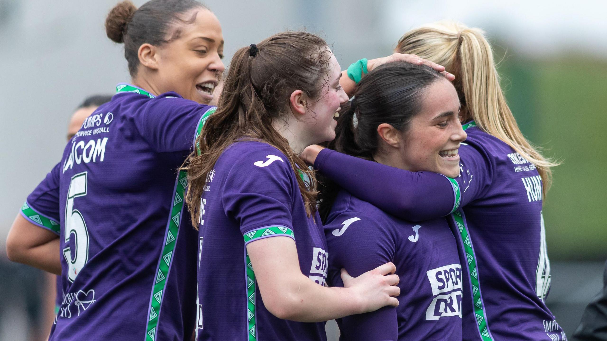 Hibs players celebrate with Poppy Lawson