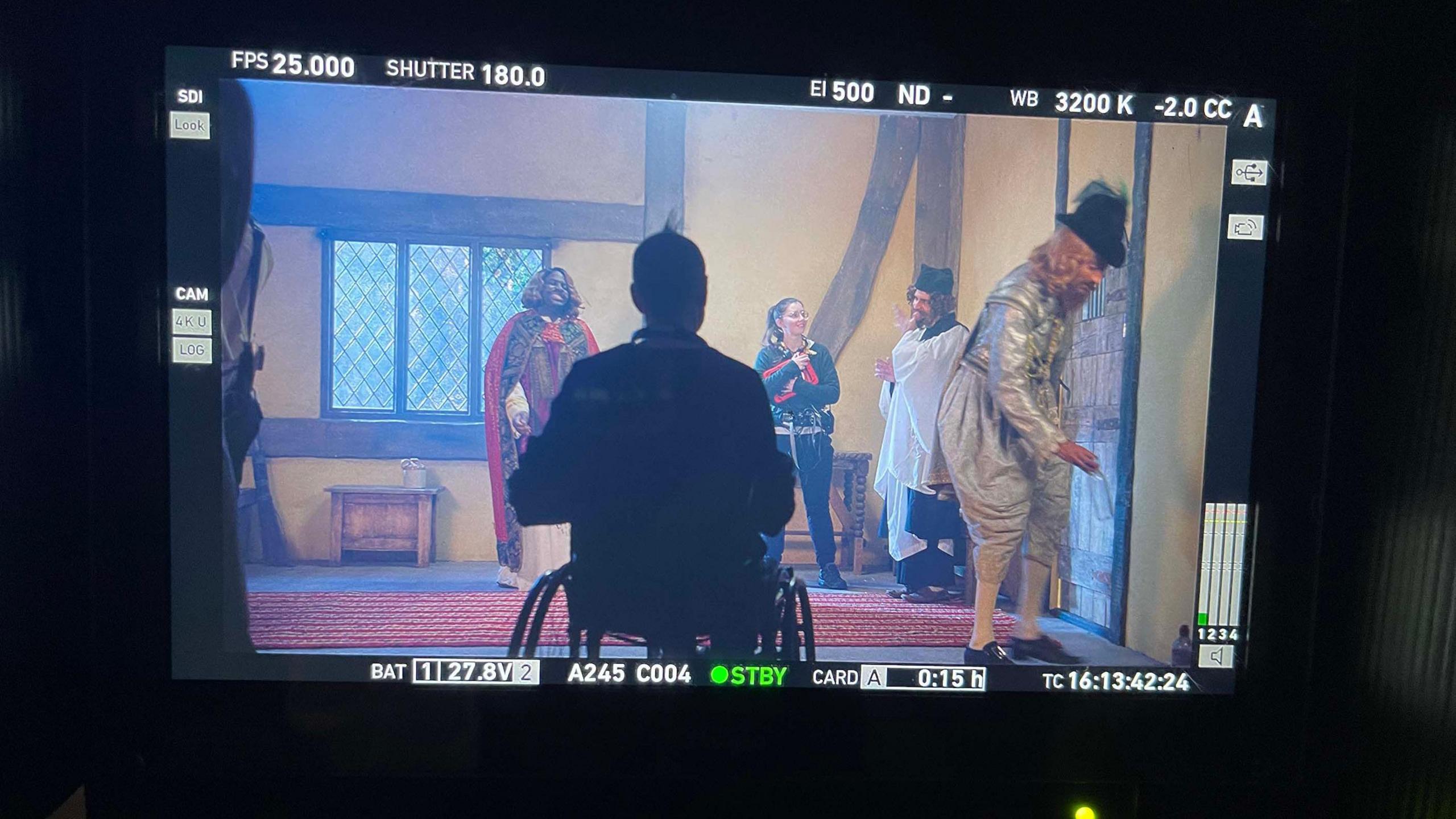 The photo shows a camera preview scene where Owen can be seen in front of a set