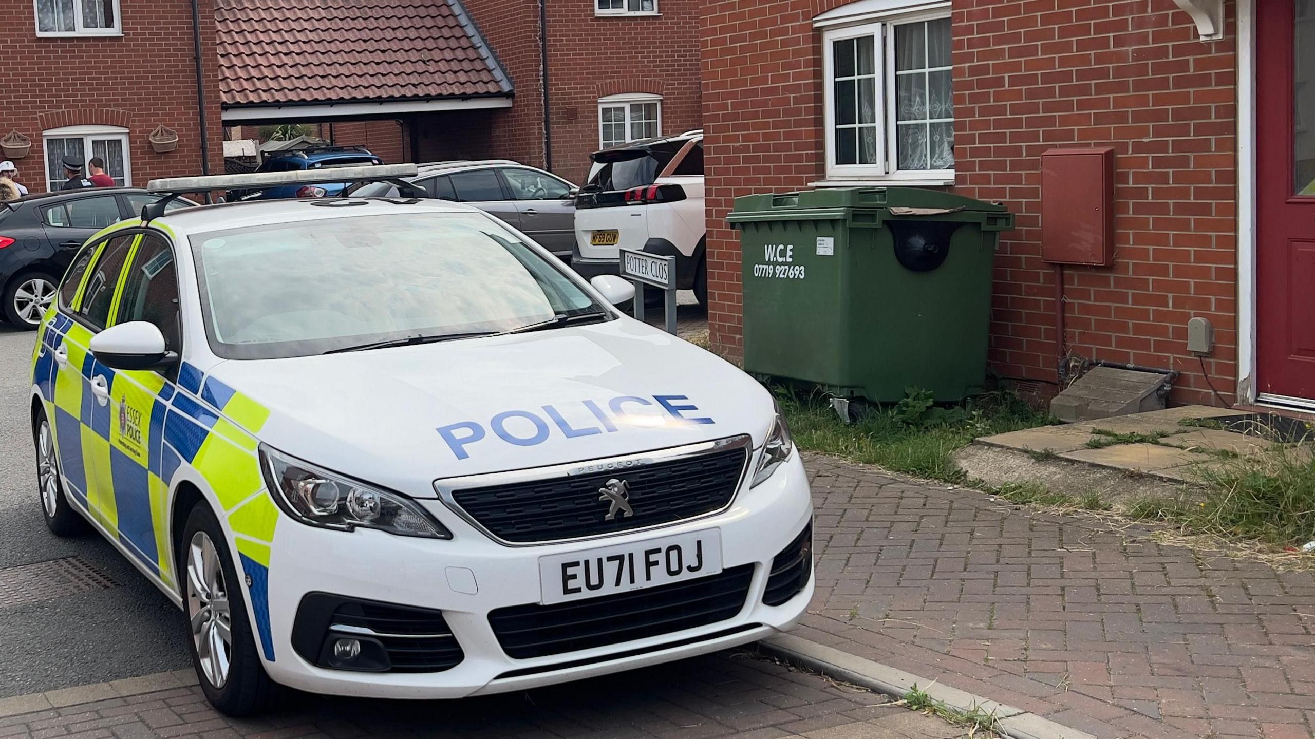 A police car parked outside a residential house