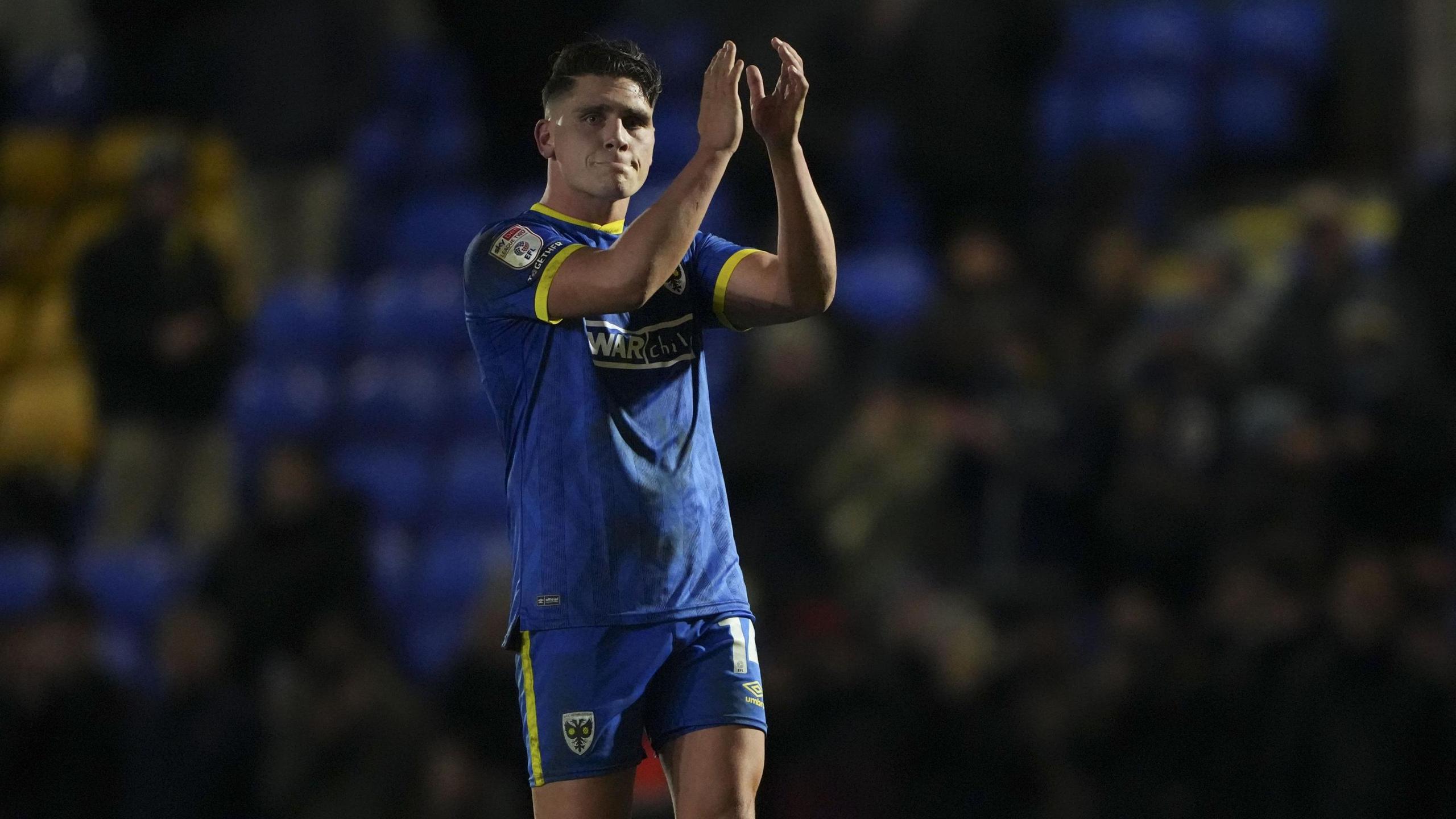 Matty Stevens applauds the AFC Wimbledon fans after their 1-0 win against Gillingham