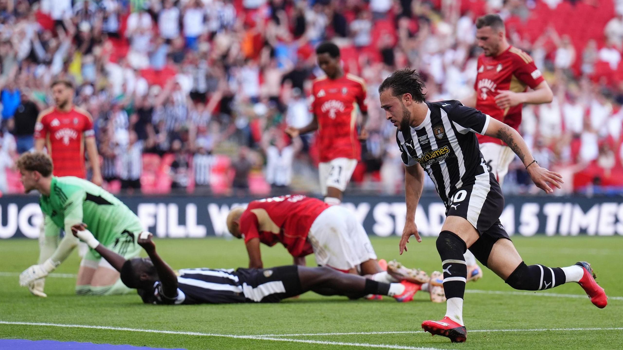 Notts County's Jodi Jones runs away to celebrate after scoring his side's third goal against Salford in the League Two play-off final at Wembley