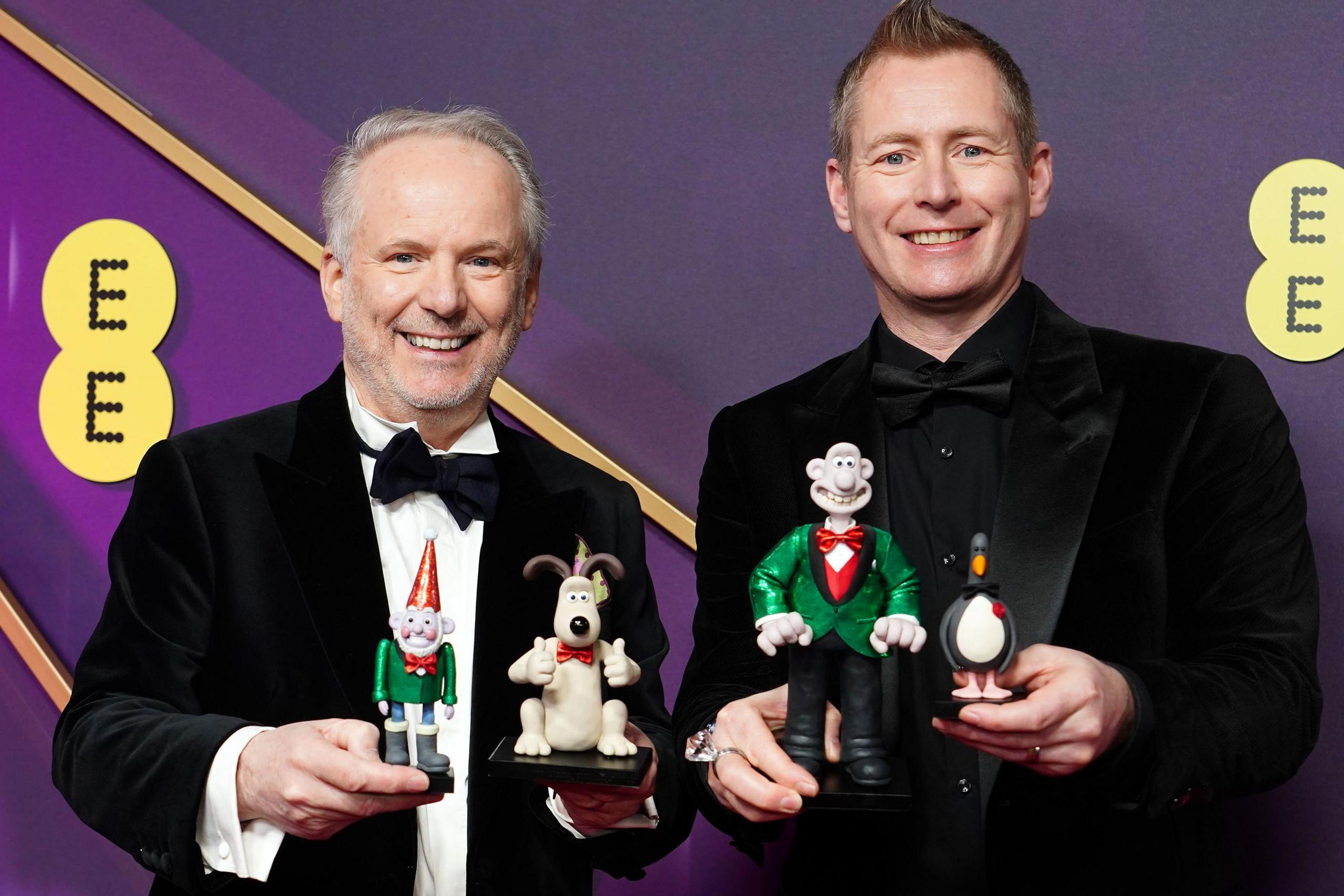 Nick Park and Merlin Crossingham and with their Wallace and Gromit models