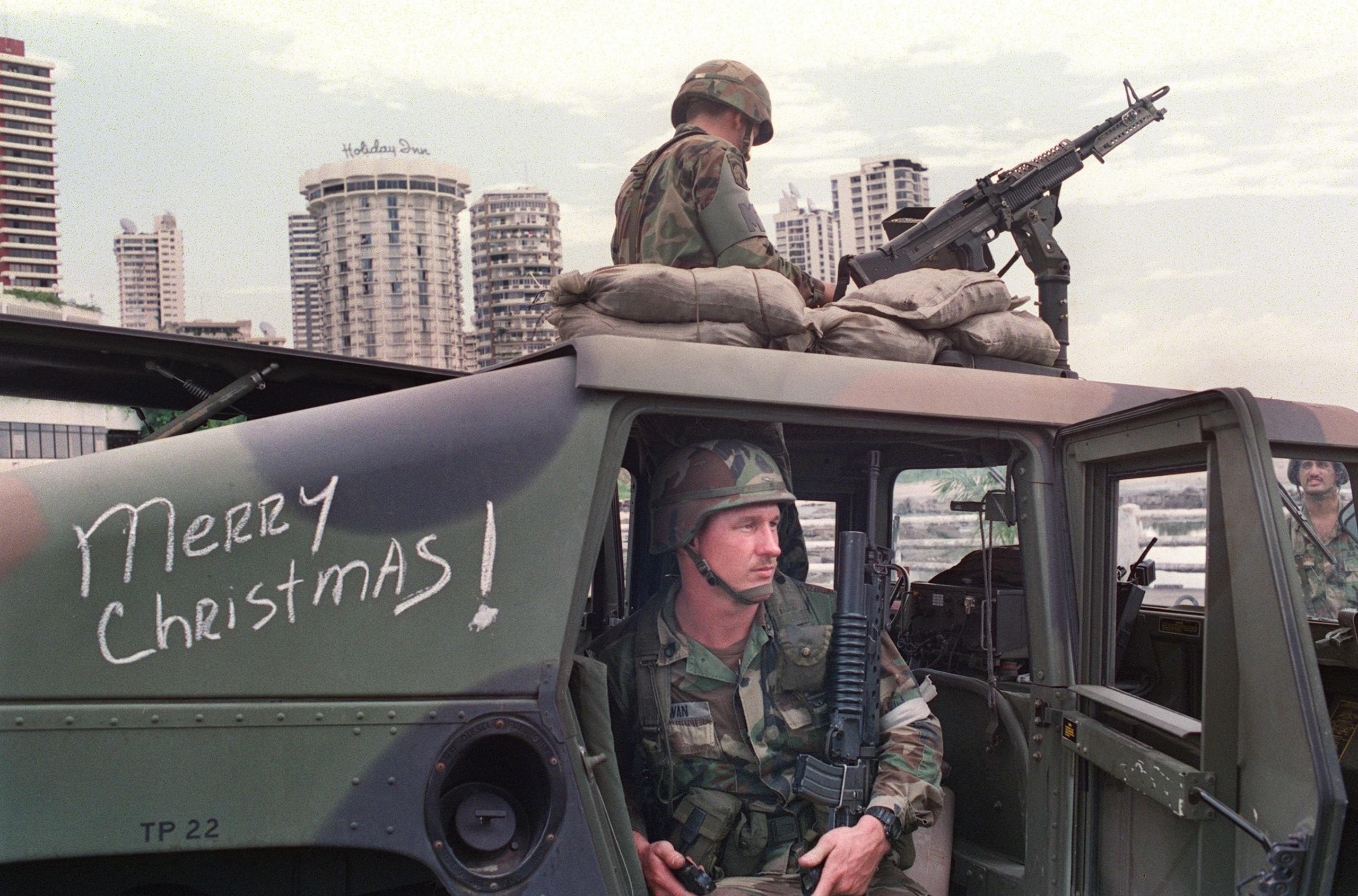 US soldiers man their security position outside the Vatican embassy in Panama City, where Panamanian General Manuel Noriega was seeking asylum, on December 25, 1989.