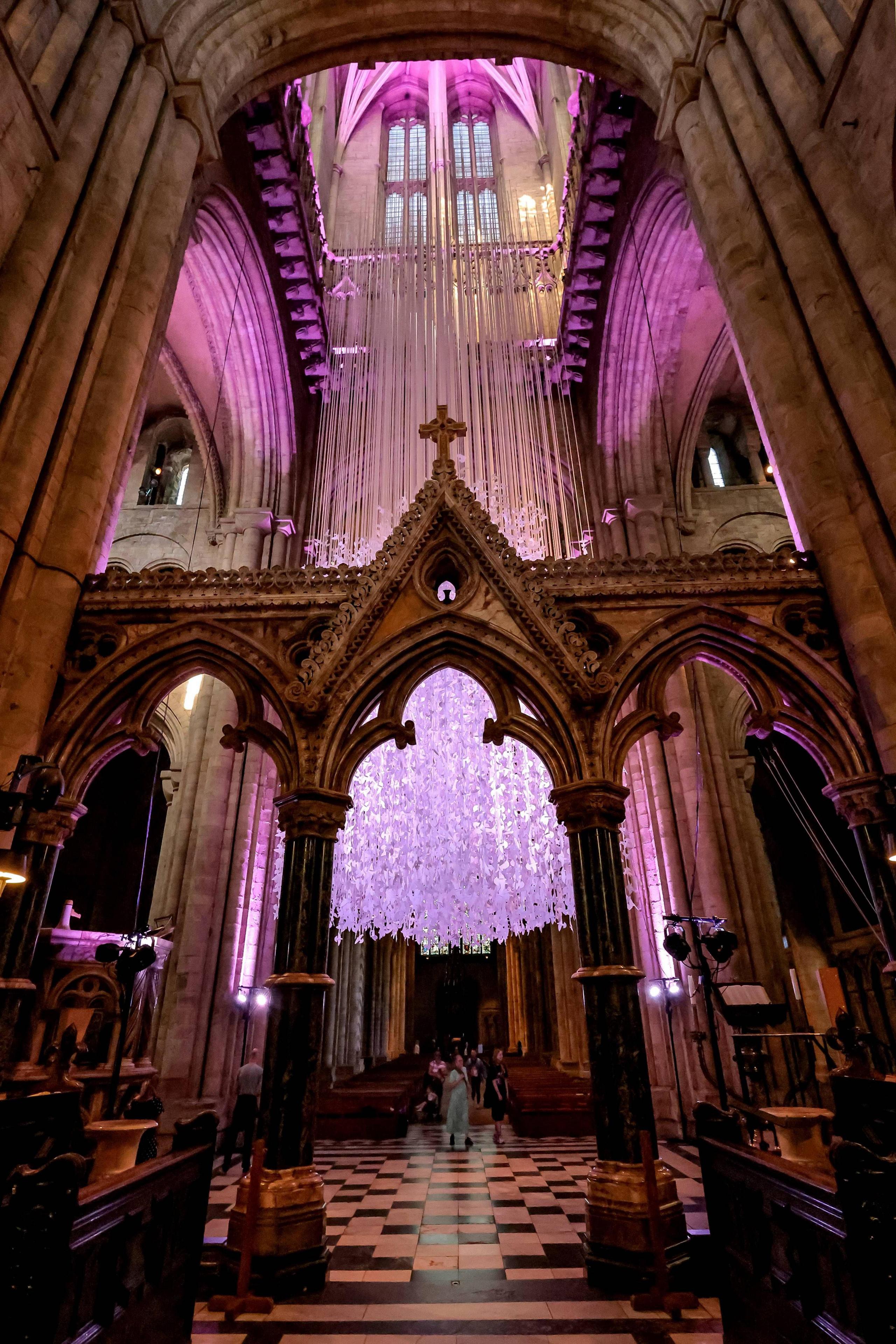 The Peace Doves installation, comprising thousands of handmade paper birds, hanging at Durham Cathedral