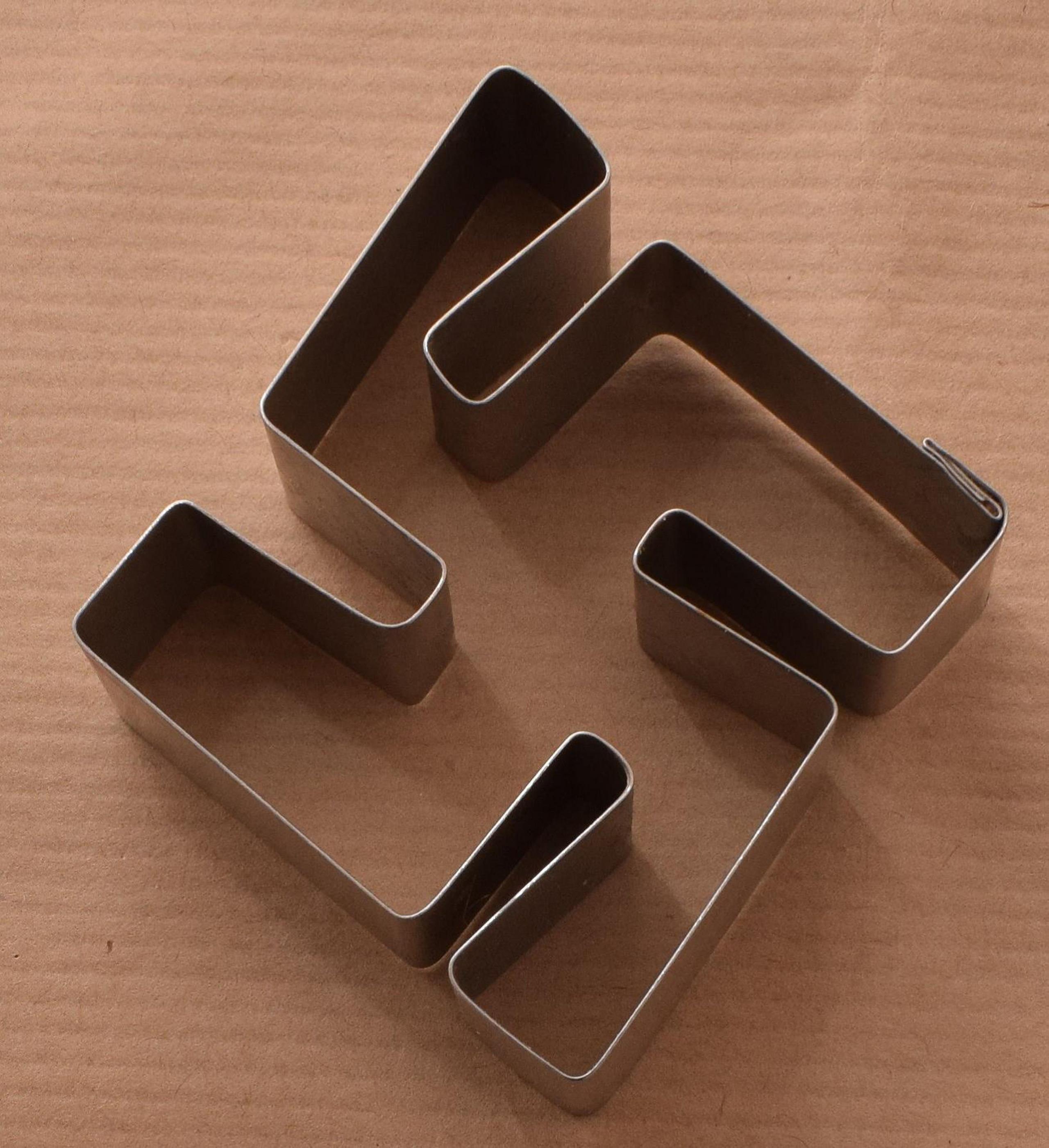 A cookie cutter shaped like a Swastika