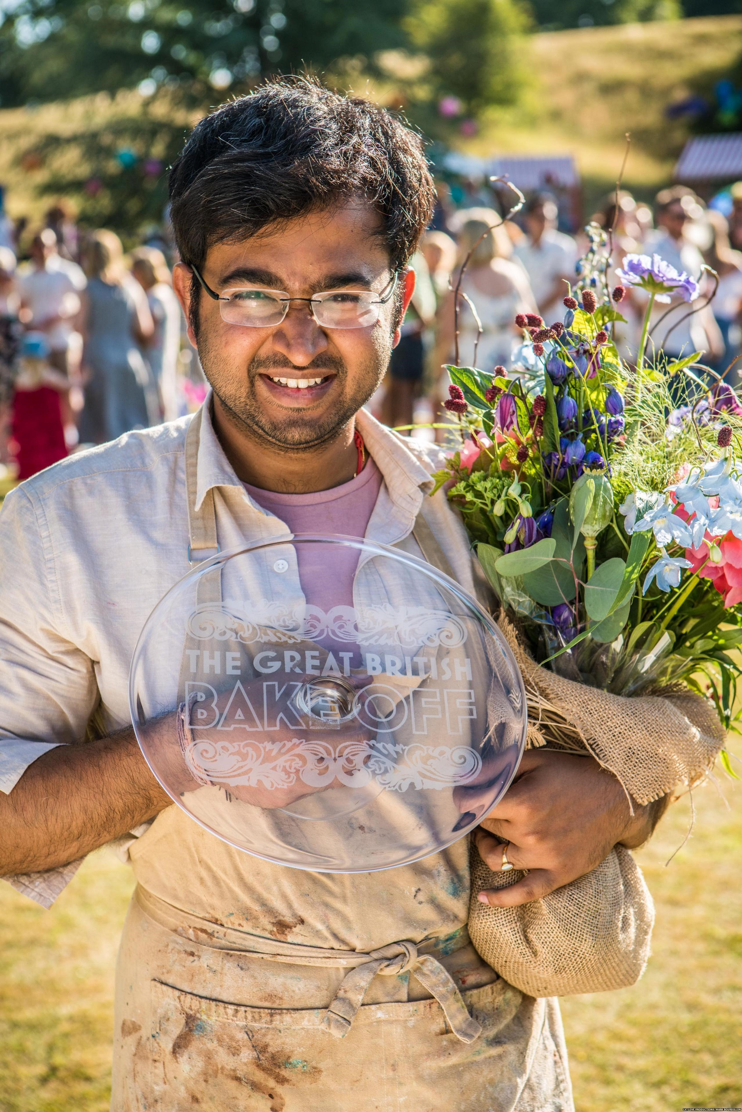 Rahul Mandal holding the Great British Bake Off winning trophy