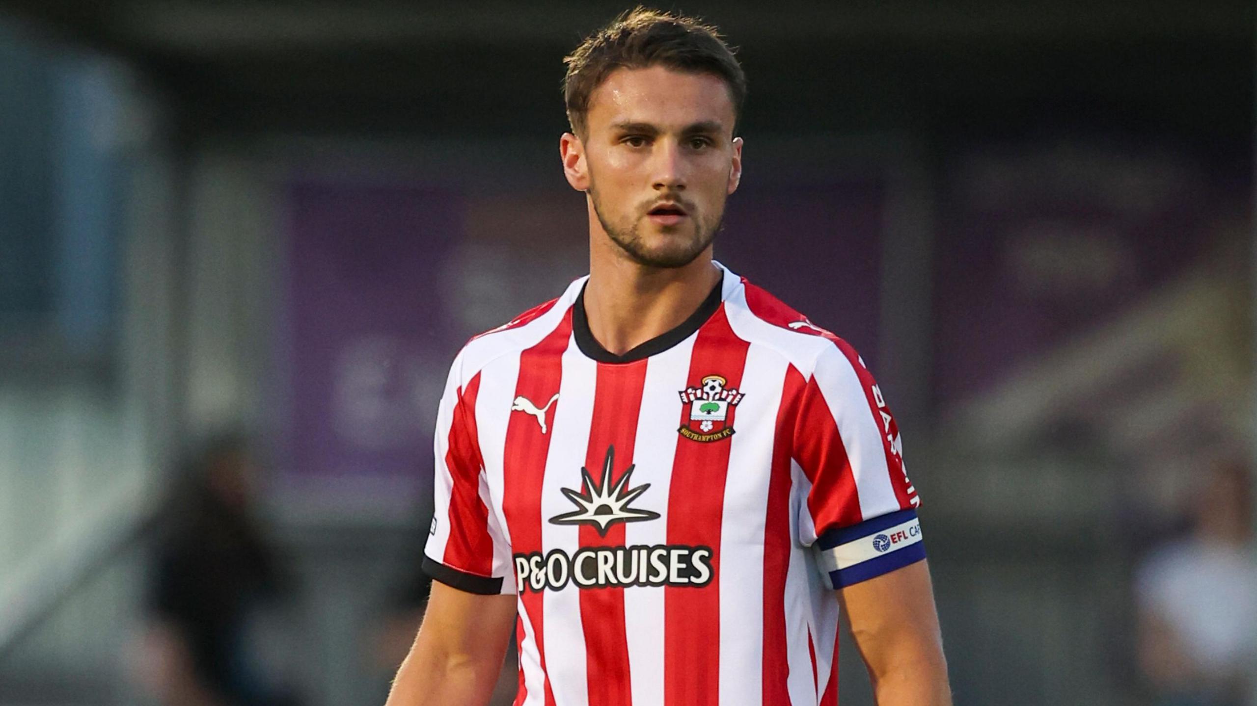 Taylor Harwood-Bellis in action for Southampton wearing a red and white shirt