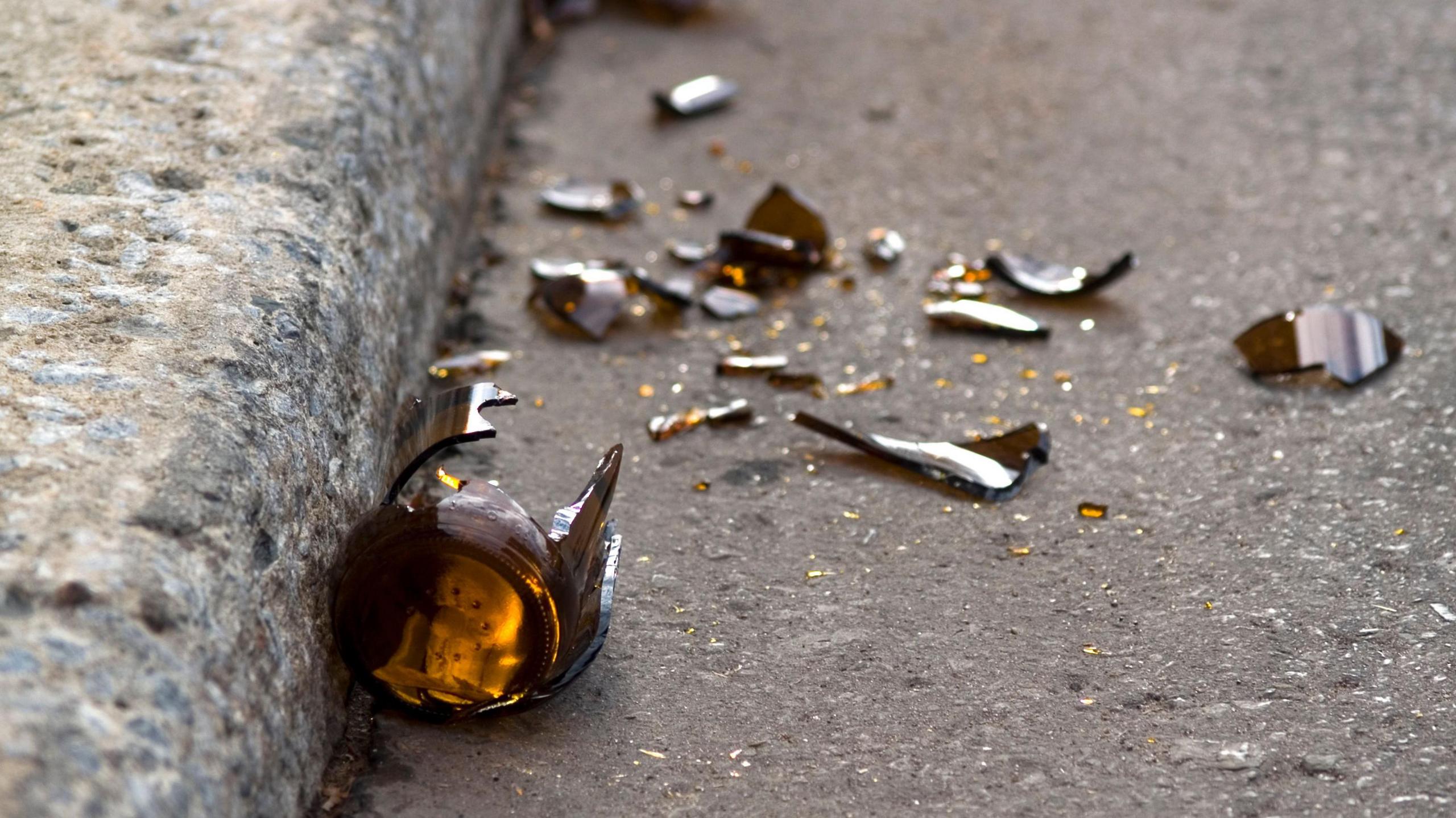 Broken glass bottle on the floor. 