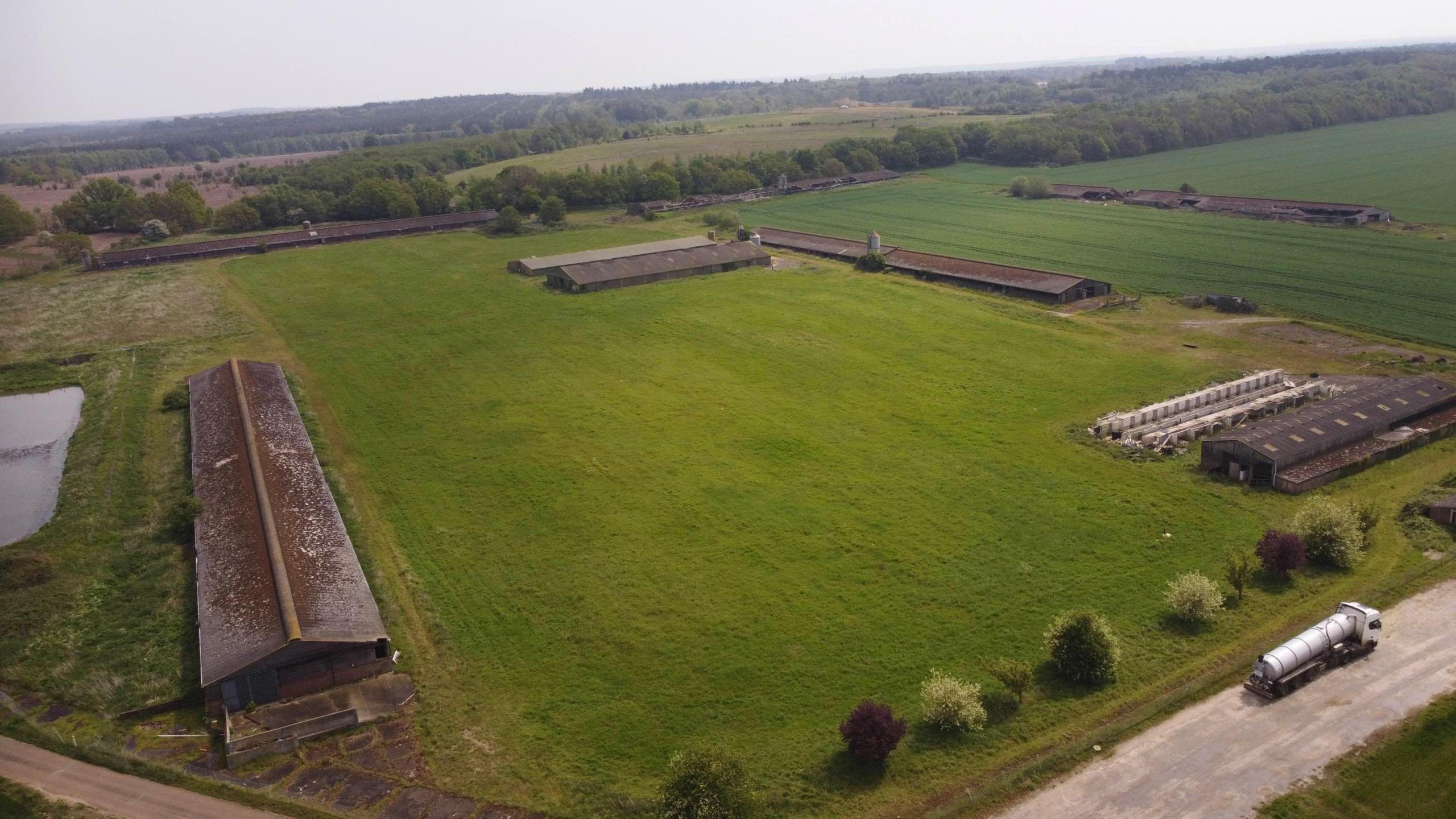 The agricultural land in Methwold with various buildings, including three old chicken sheds.