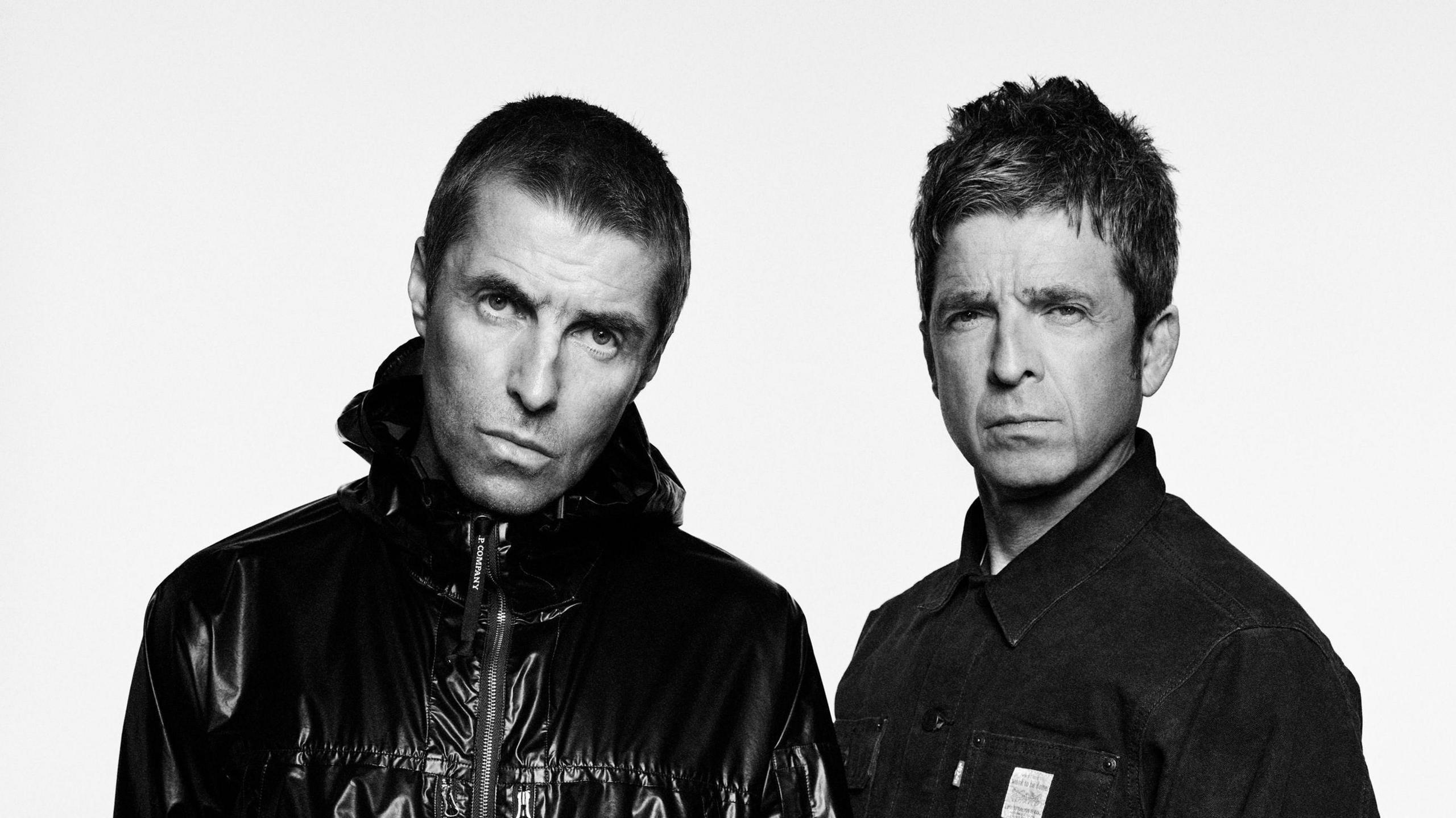 A black and white picture of Liam and Noel Gallagher released as part of the promotion for the Oasis reunion tour.