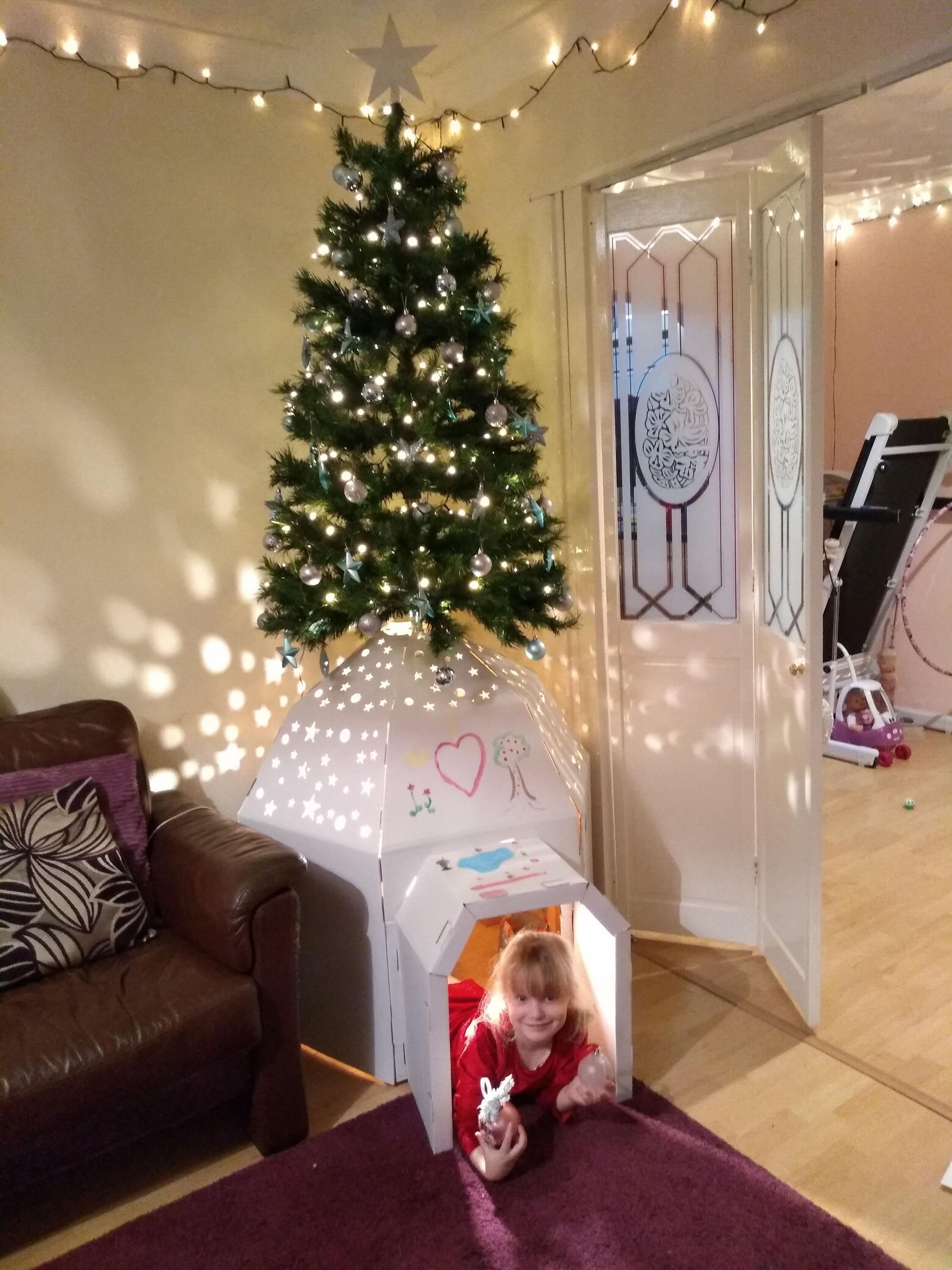 Image of a girl under a tree with an igloo